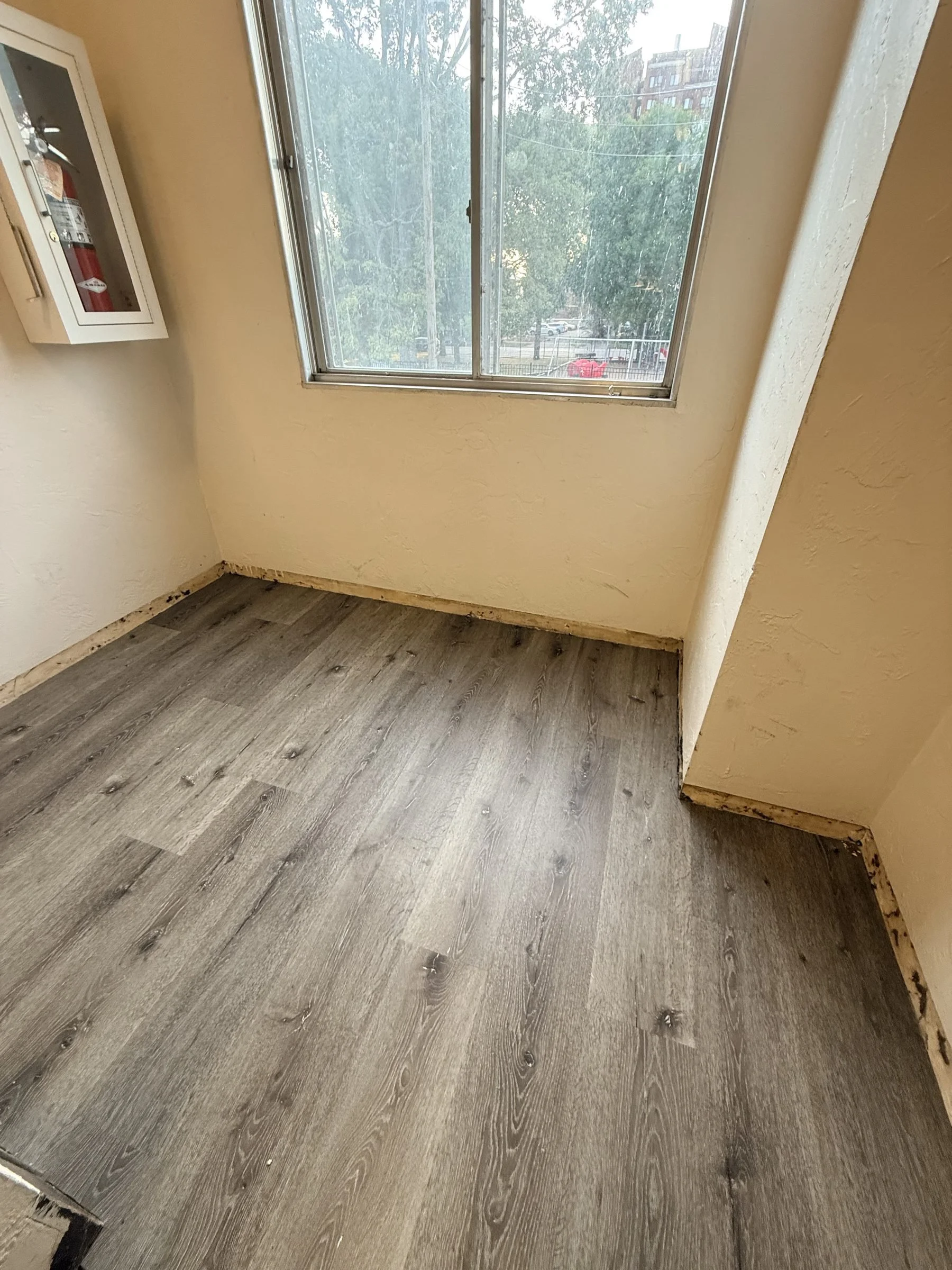 LVP flooring in apartment unit room with window