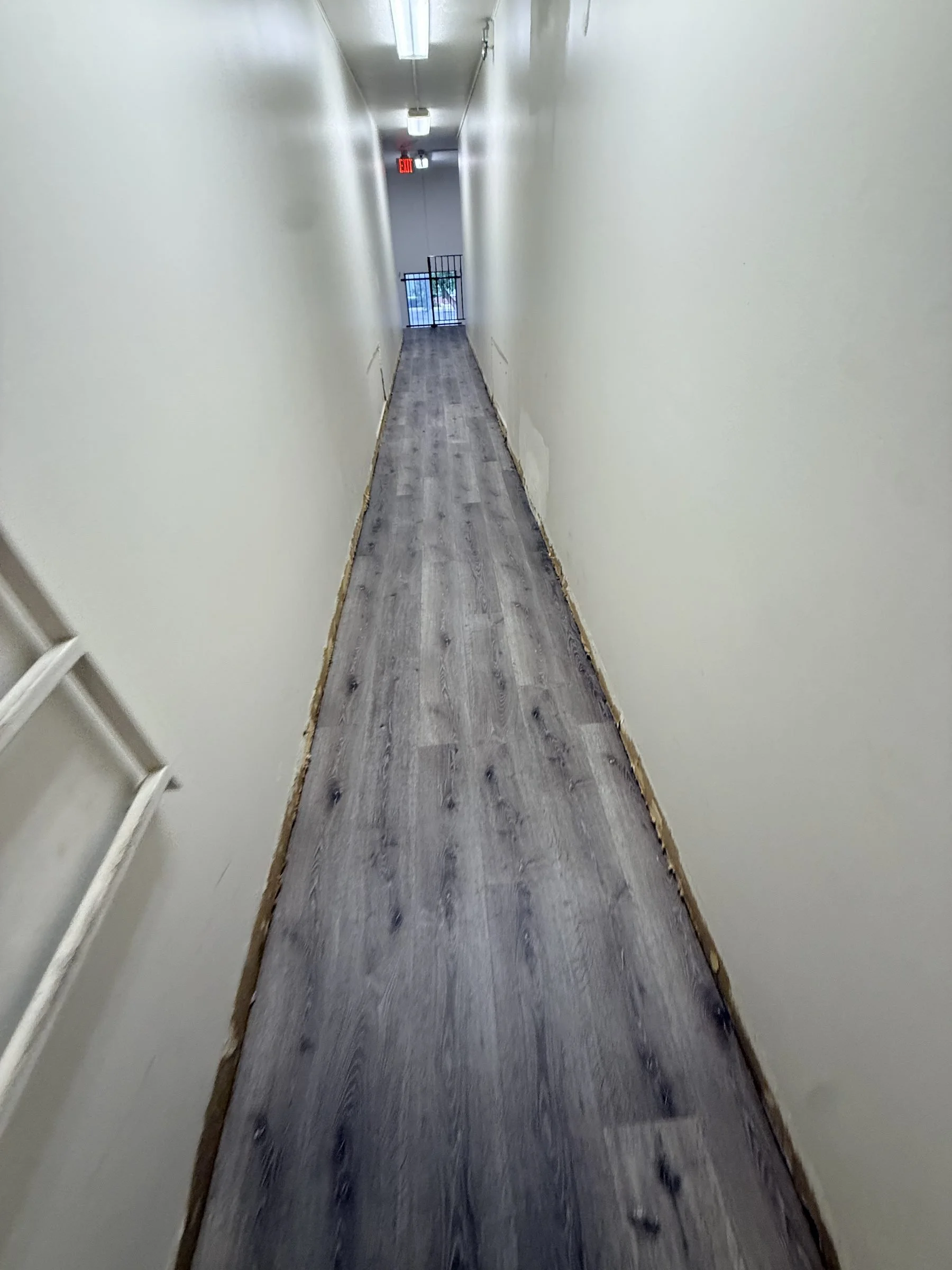 LVP flooring in long apartment hallway