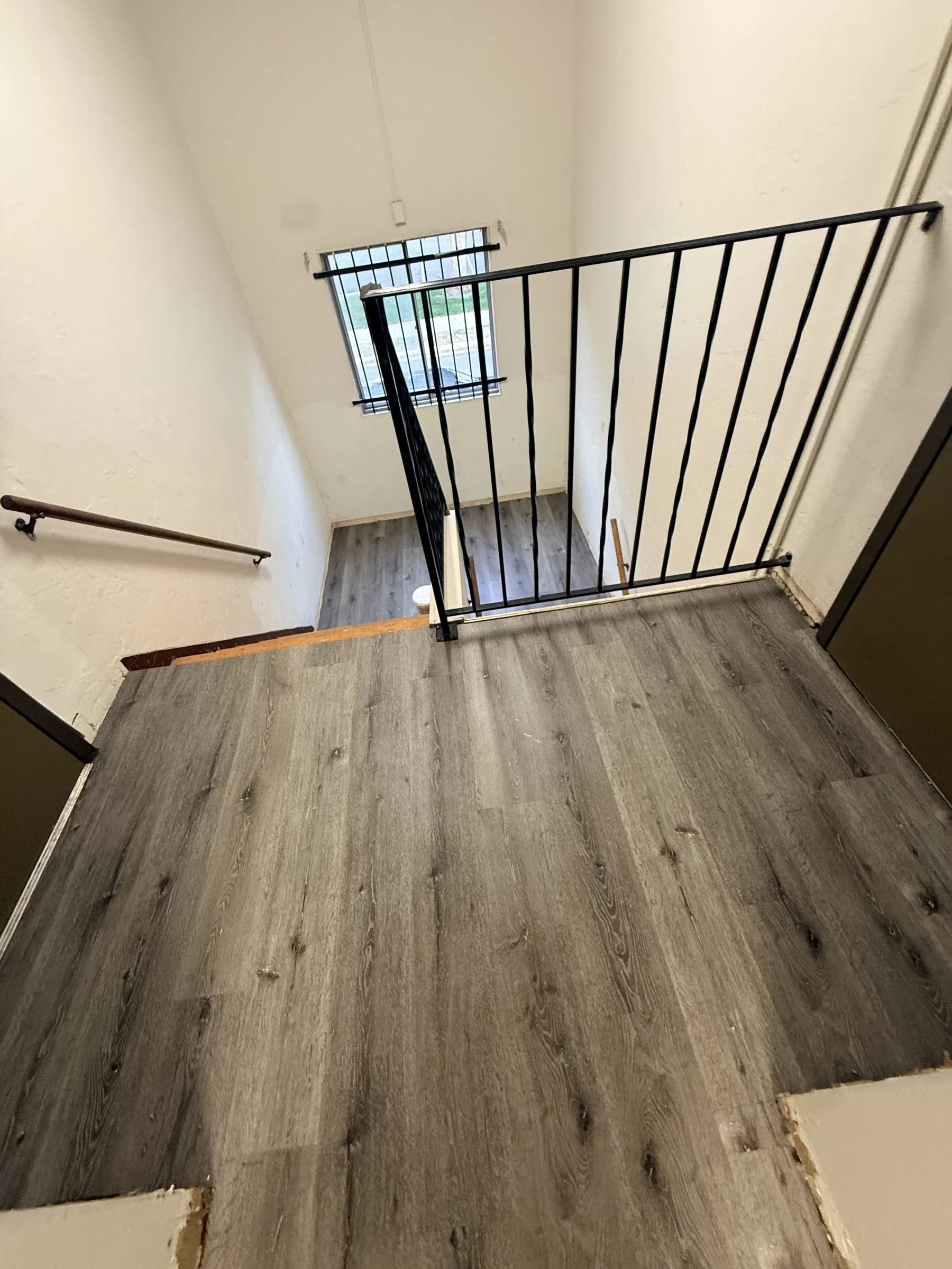 LVP flooring on apartment stair landing with railing