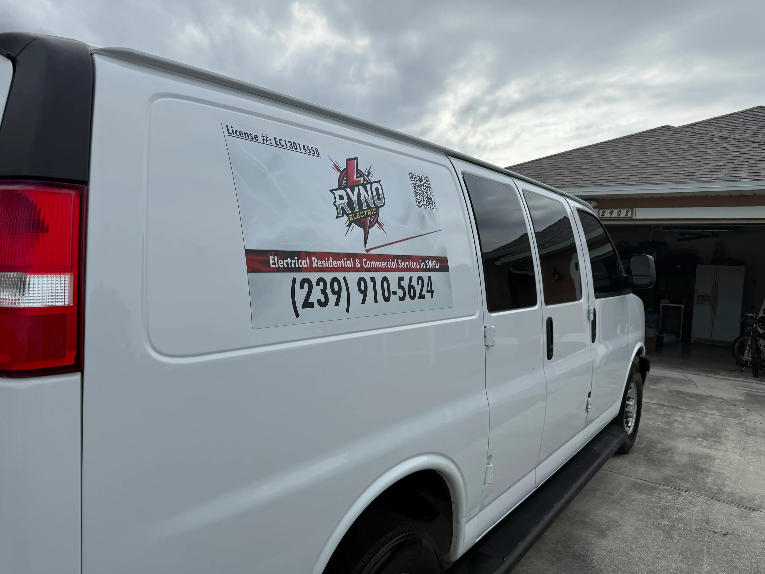 Branded electrical service van parked in a residential driveway, featuring clear company signage, license information, and contact details. This image highlights professional residential and commercial electrical services, reliable local electrician 