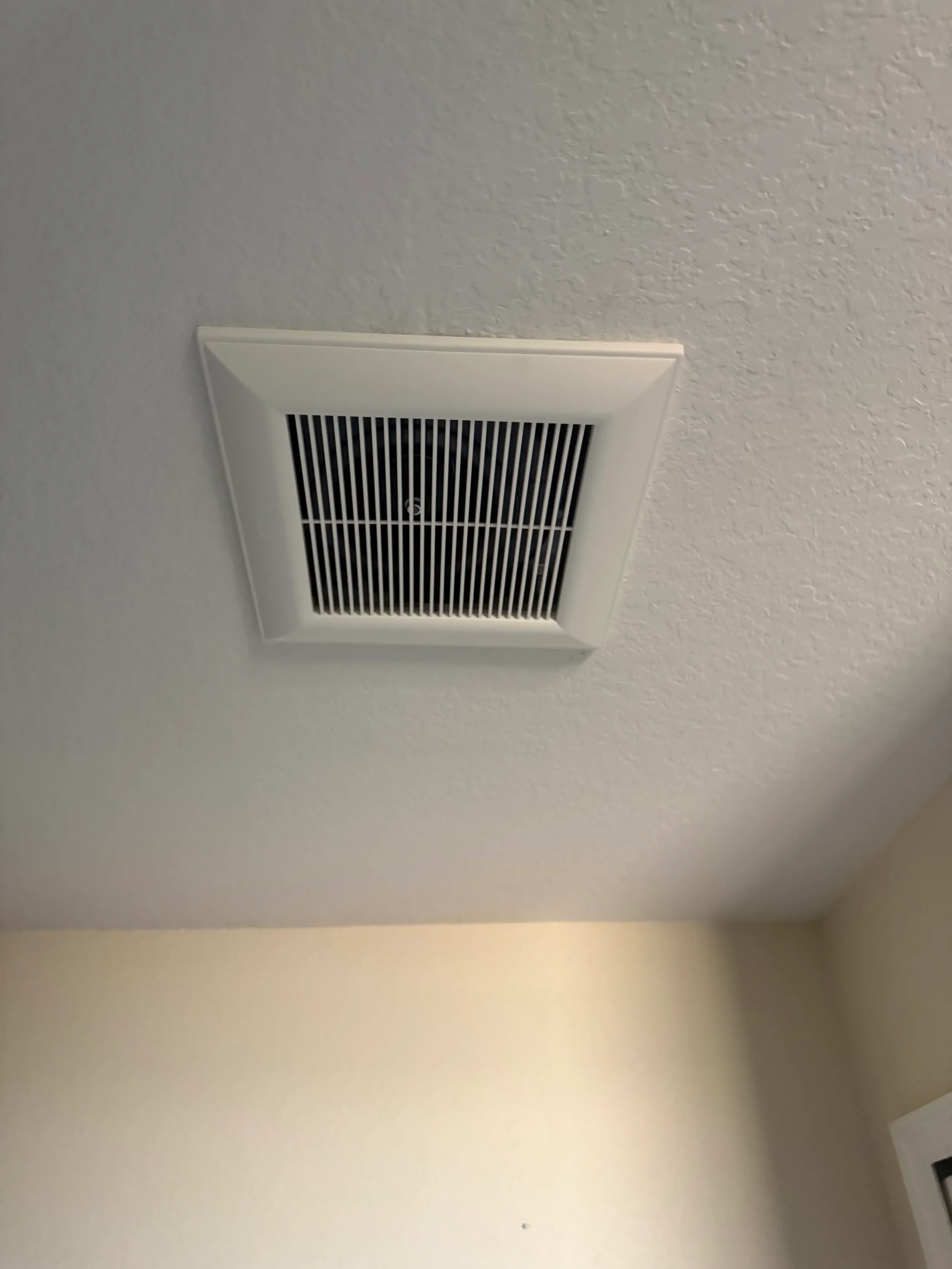 Ceiling-mounted bathroom exhaust fan installed to improve ventilation, remove excess moisture, and prevent mold and mildew buildup. This image showcases a clean, modern residential ventilation upgrade designed to enhance indoor air quality and bathro
