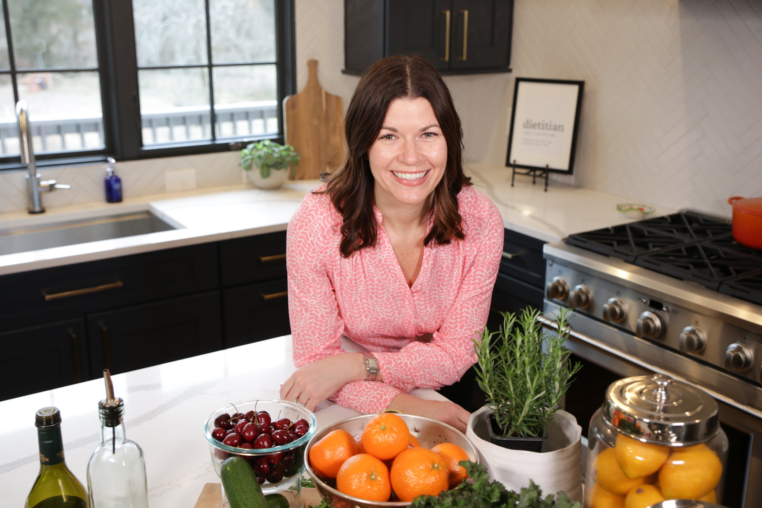 Megan Bishop, Registered Dietitian Nutritionist, standing in a kitchen with fresh vegetables