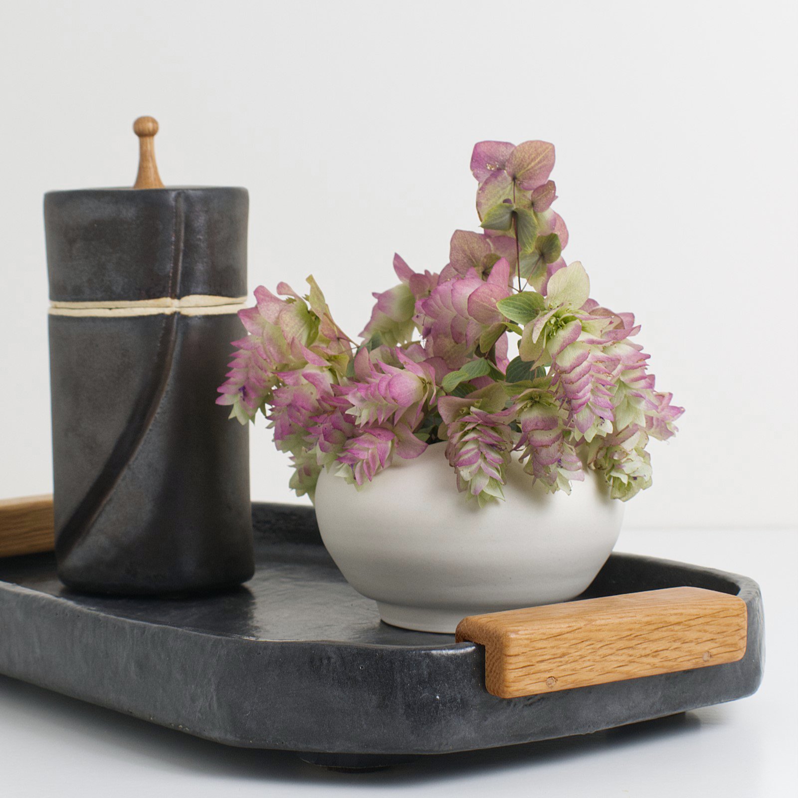 Noir tray with flowers lidded jar.jpg