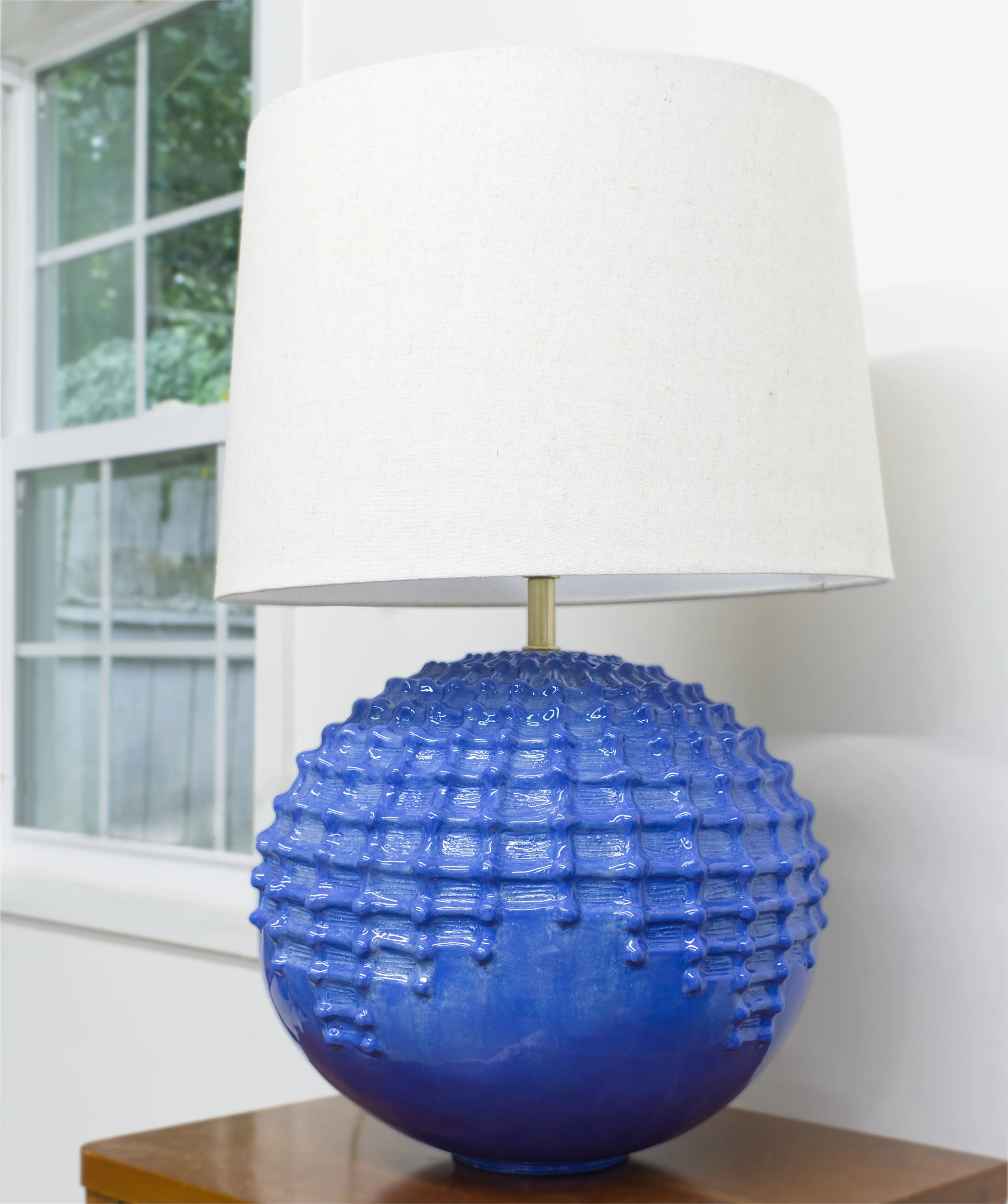 sculpted orb ceramic lamp by window.jpg