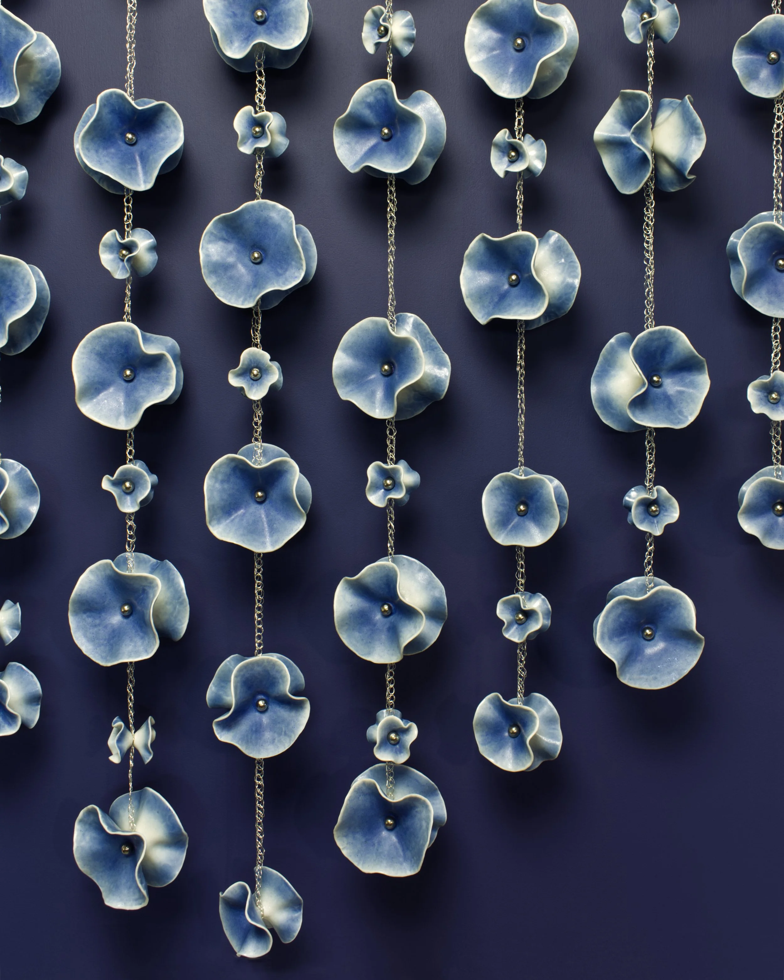 "Periwinkle Hanging Fleurettes", porcelain, crocheted silver wire, nickel, oak