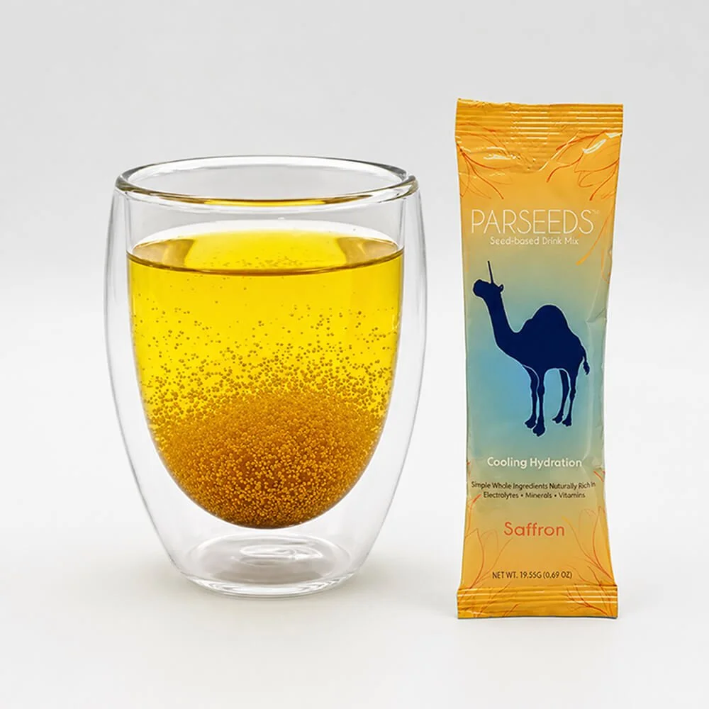 Glass of PARSEEDS khakshir and saffron drink beside stick pack