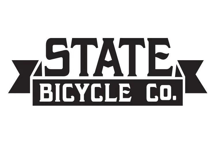 Logo for State Bicycle Co. in black and white, featuring bold stylized text and banner elements.