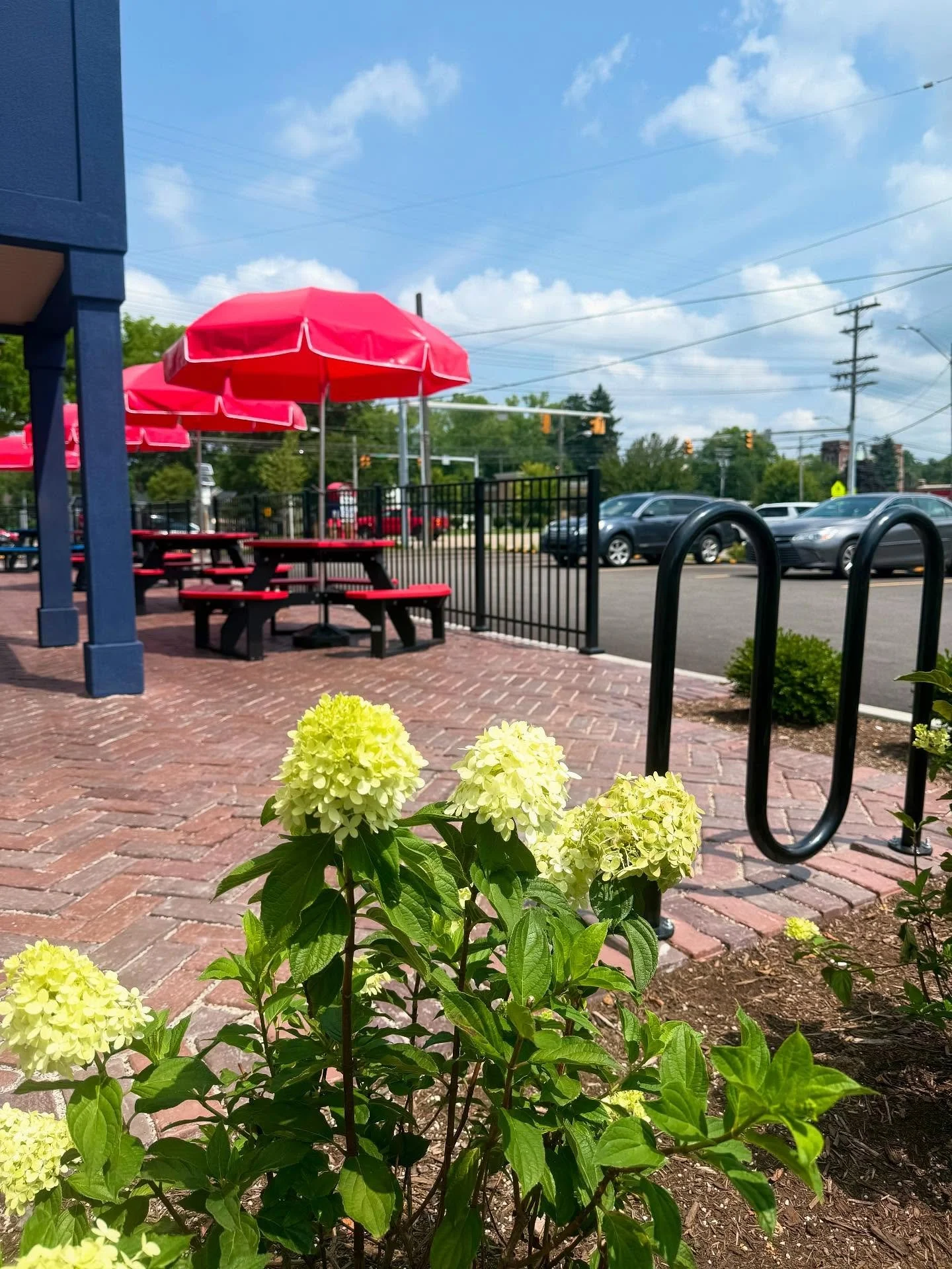 Over 1,100 sq. ft. of @unilock Town Hall pavers installed in a herringbone pattern using a three-color blend, complete with a soldier course border. The perfect solution to comply with a permeable paver requirement from the city while adding aestheti
