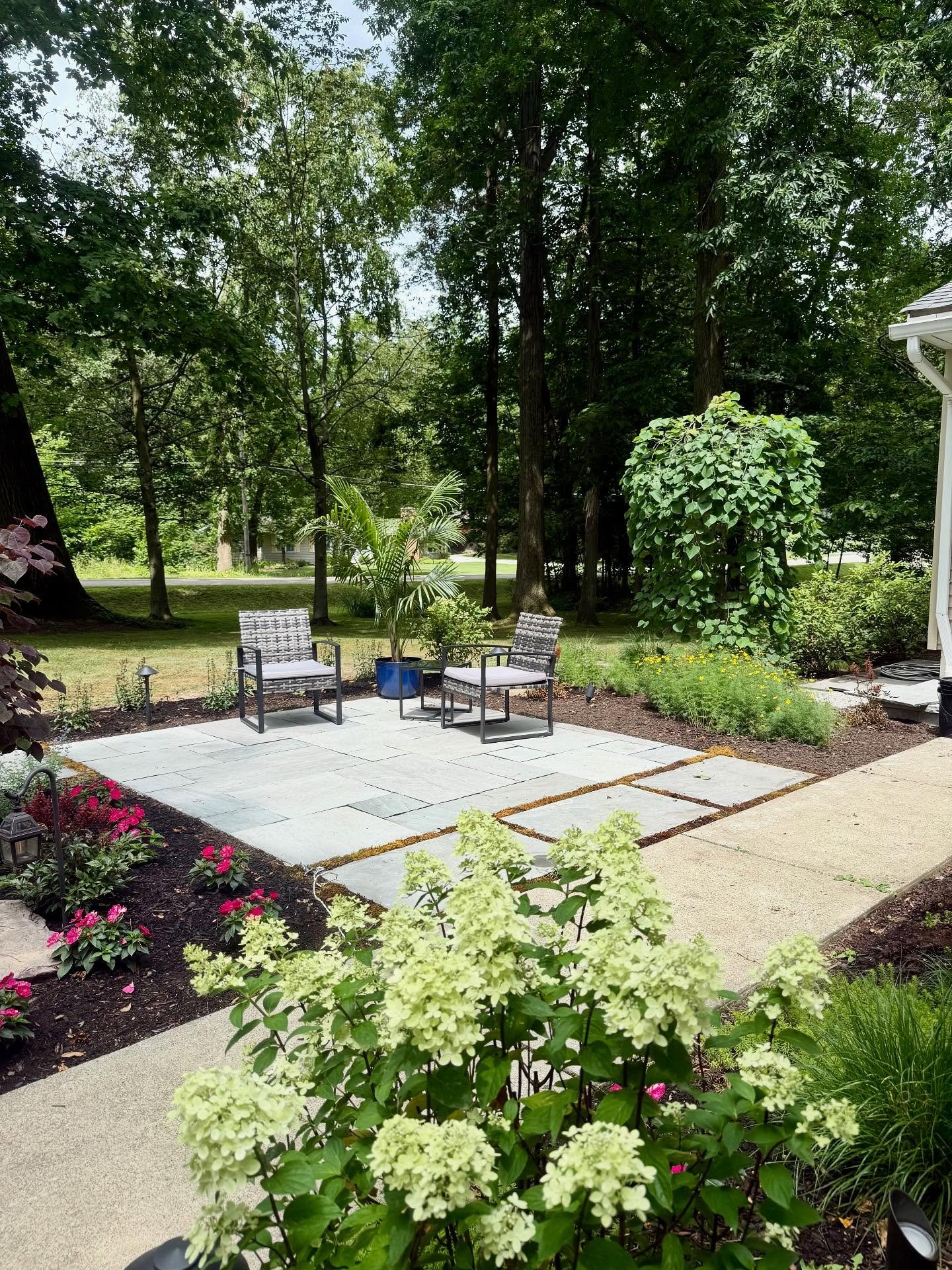Completed this small patio project this past summer, made from a beautiful natural stone. It&rsquo;s the perfect spot to relax and unwind among the variety of shrubs, perennials and trees. The space is even outfitted with landscape lighting to enjoy 