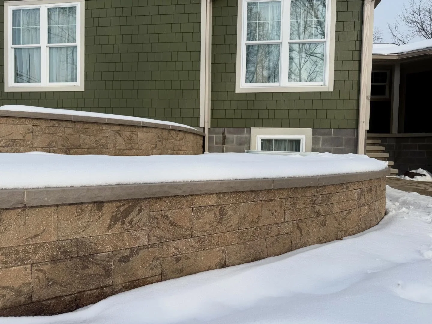 Completed this pair of @techobloc tiered retaining walls back in August. The color the clients chose beautifully complements their home and really makes a statement&mdash;especially in the snow! ❄️ This spring, we&rsquo;ll soften the space with some 