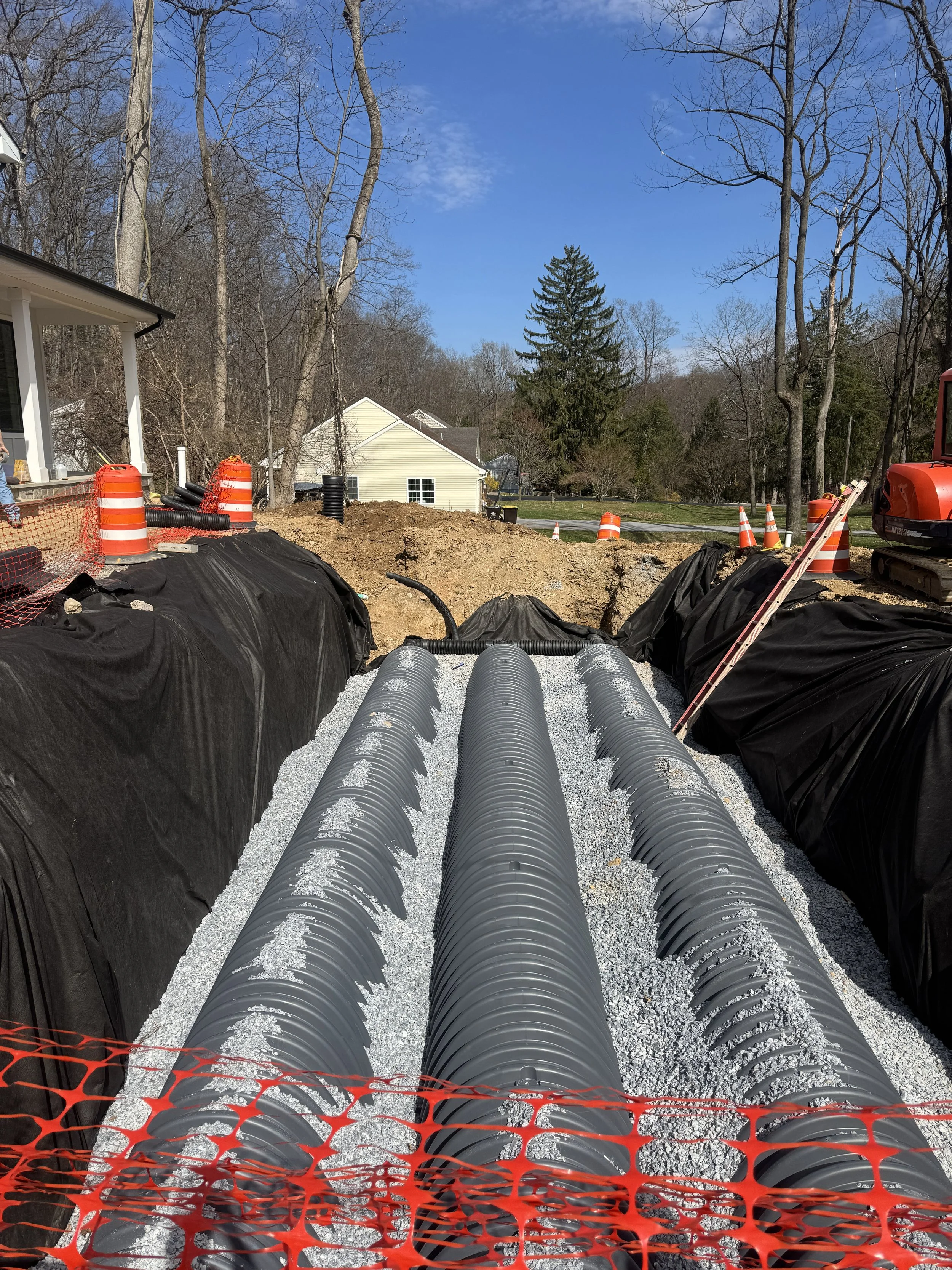 Underground stormwater infiltration pipes bedded in clean stone