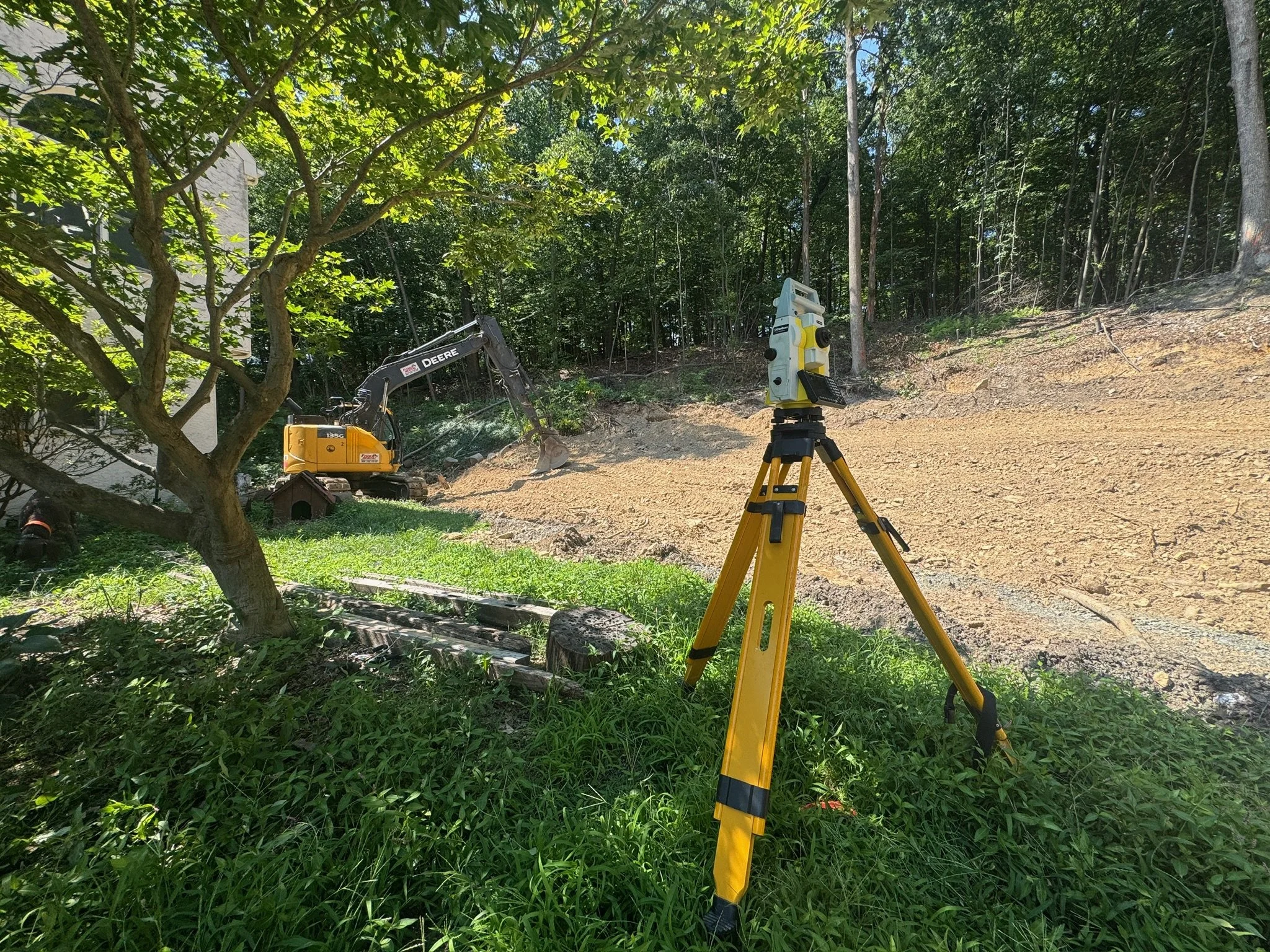 Excavator grading a residential building site