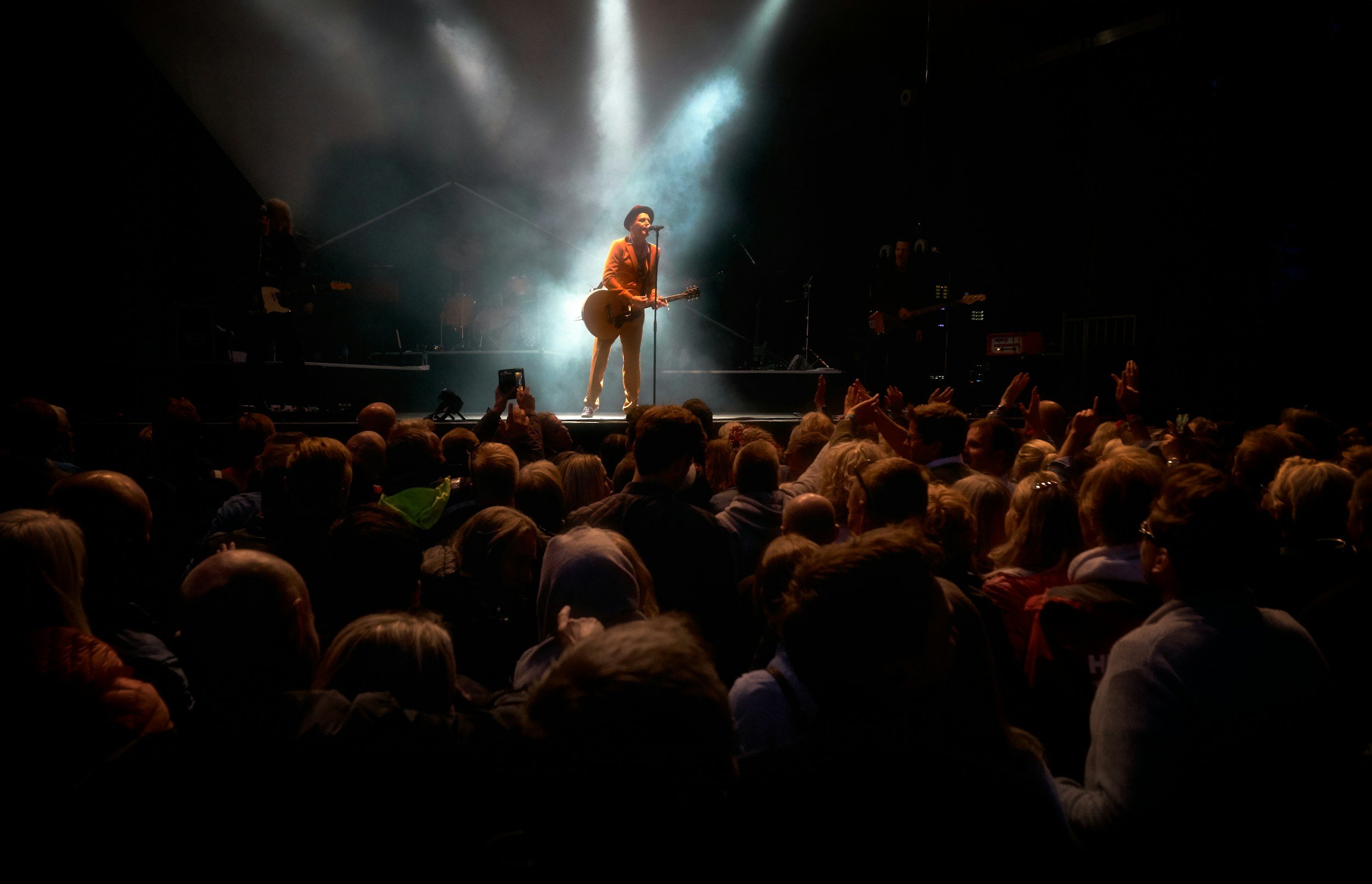 Live music performance representing audience growth for independent artists.
