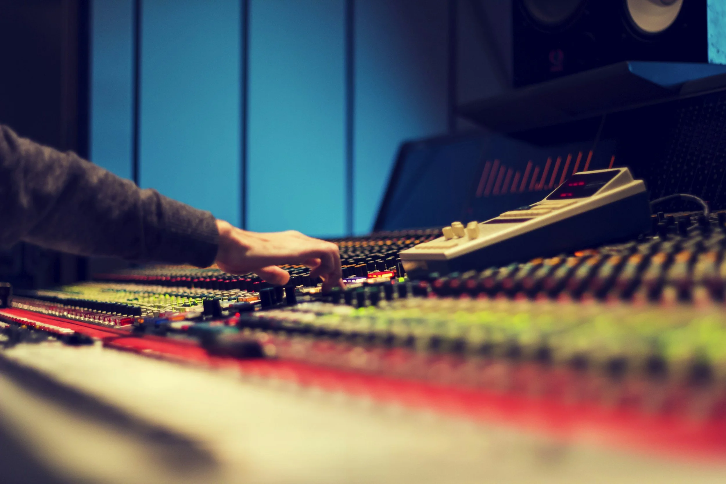 Audio engineer mixing and mastering a professionally recorded song for commercial release.