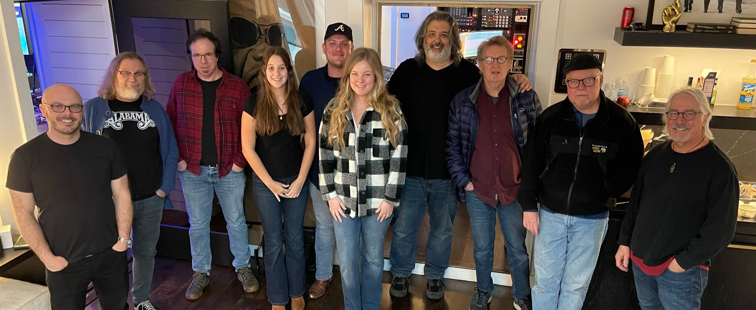 Producers, engineers, and musicians gathered in a Nashville recording studio control room at Century Music Group.