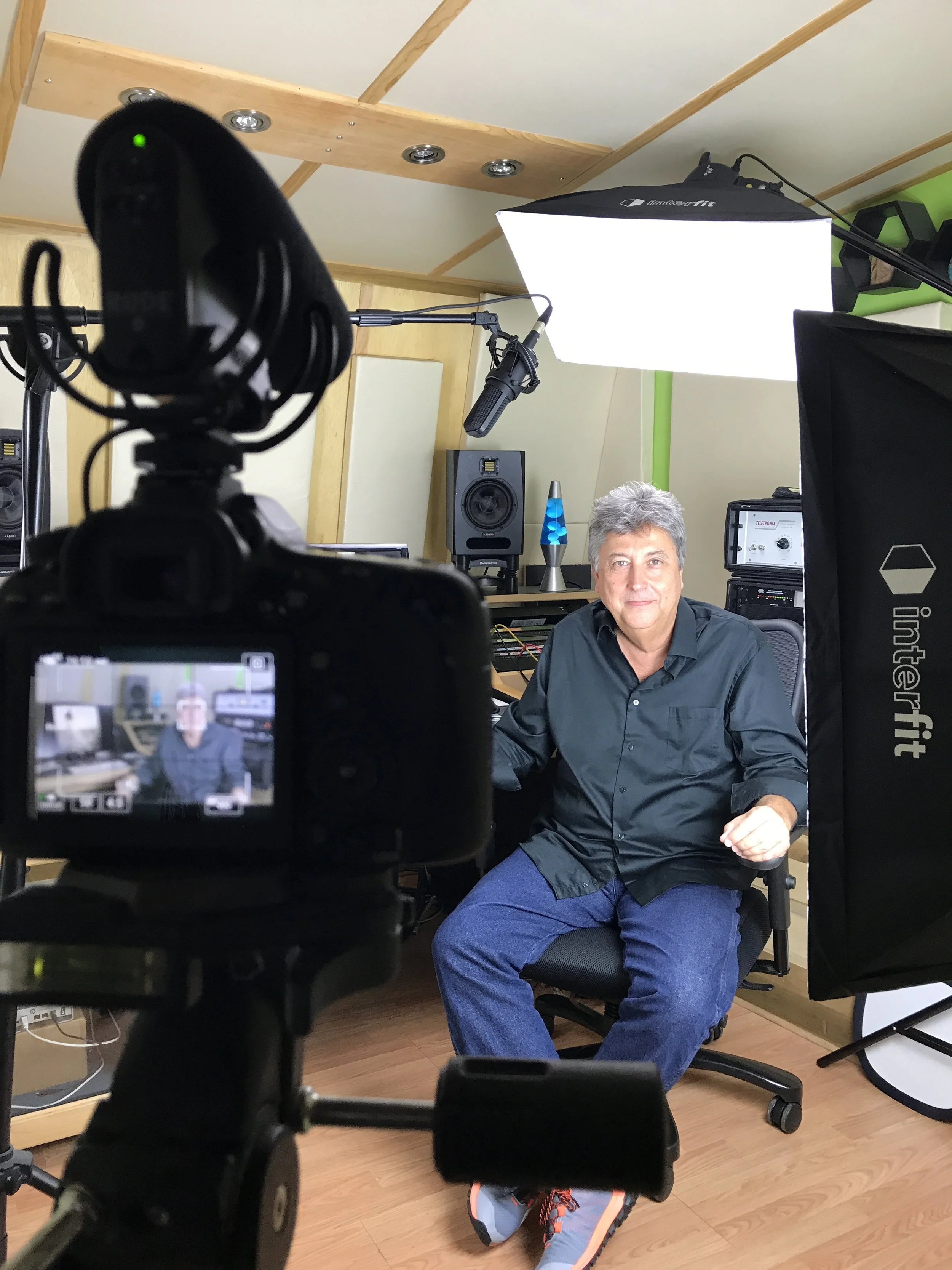 Professional video production setup with camera, lighting, microphone, and on-camera talent.