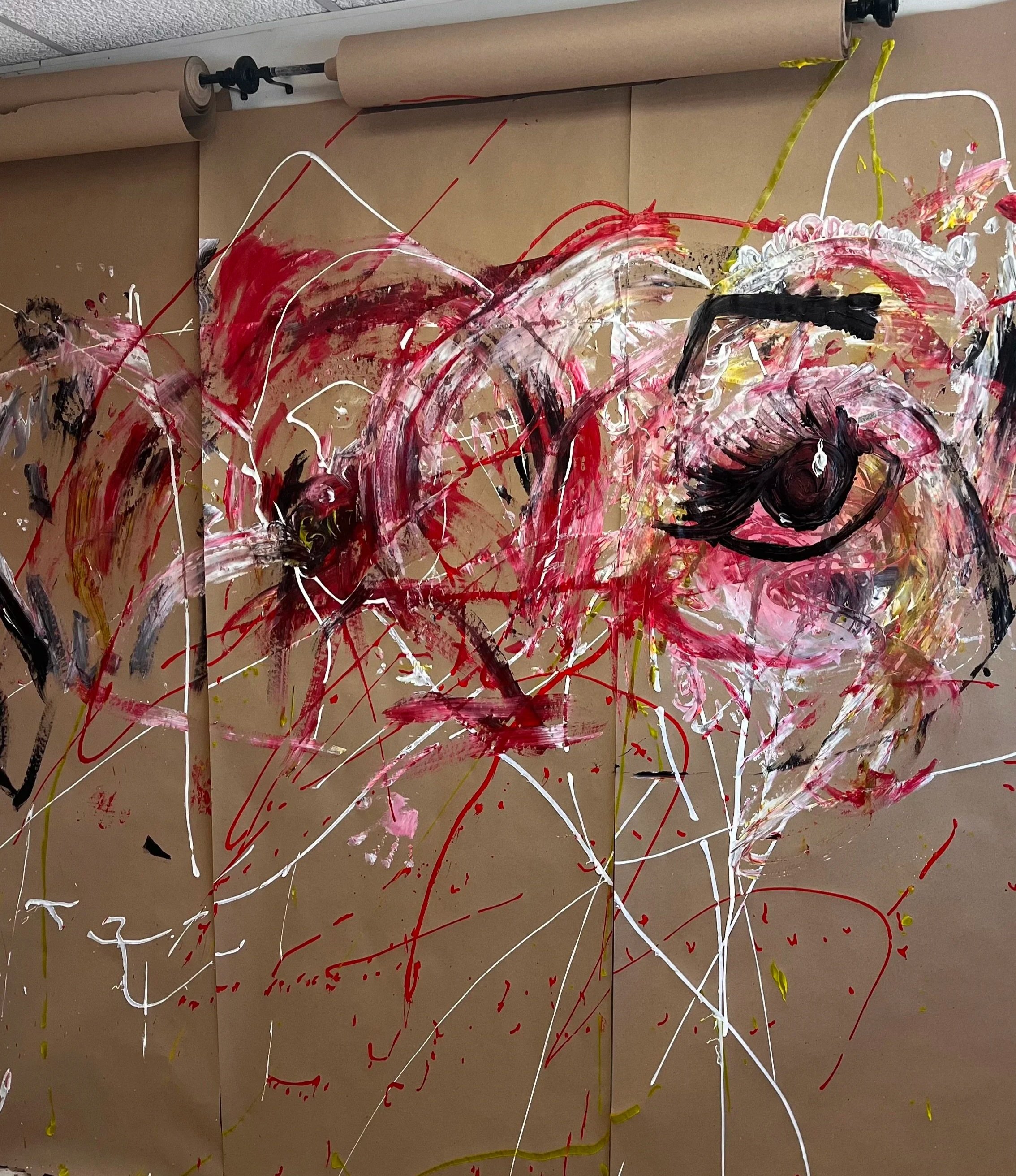 Paint Splatter  Room. Brown paper splashed with paint. Red, white, yellow, and black paint on walls. 