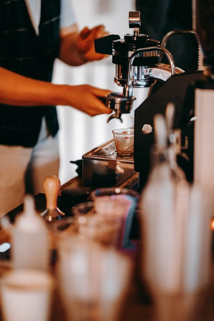 Mobile coffee cart serving espresso drinks at a beautiful Dallas-Fort Worth wedding reception, with a professional barista preparing lattes.