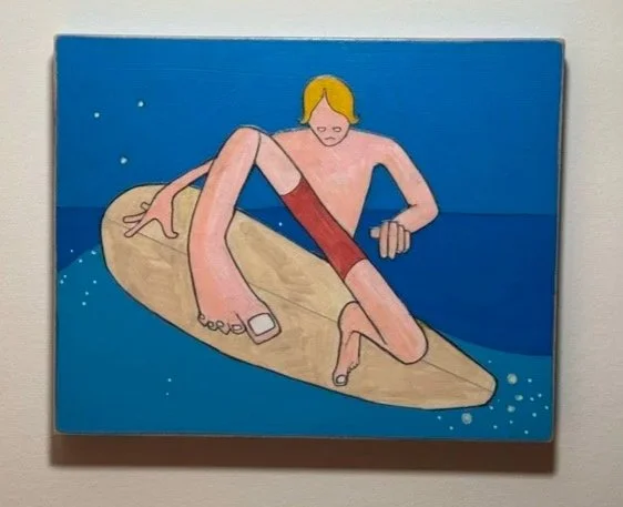 A cartoon of a man with blond hair sitting on a surfboard in the ocean, looking at his phone.