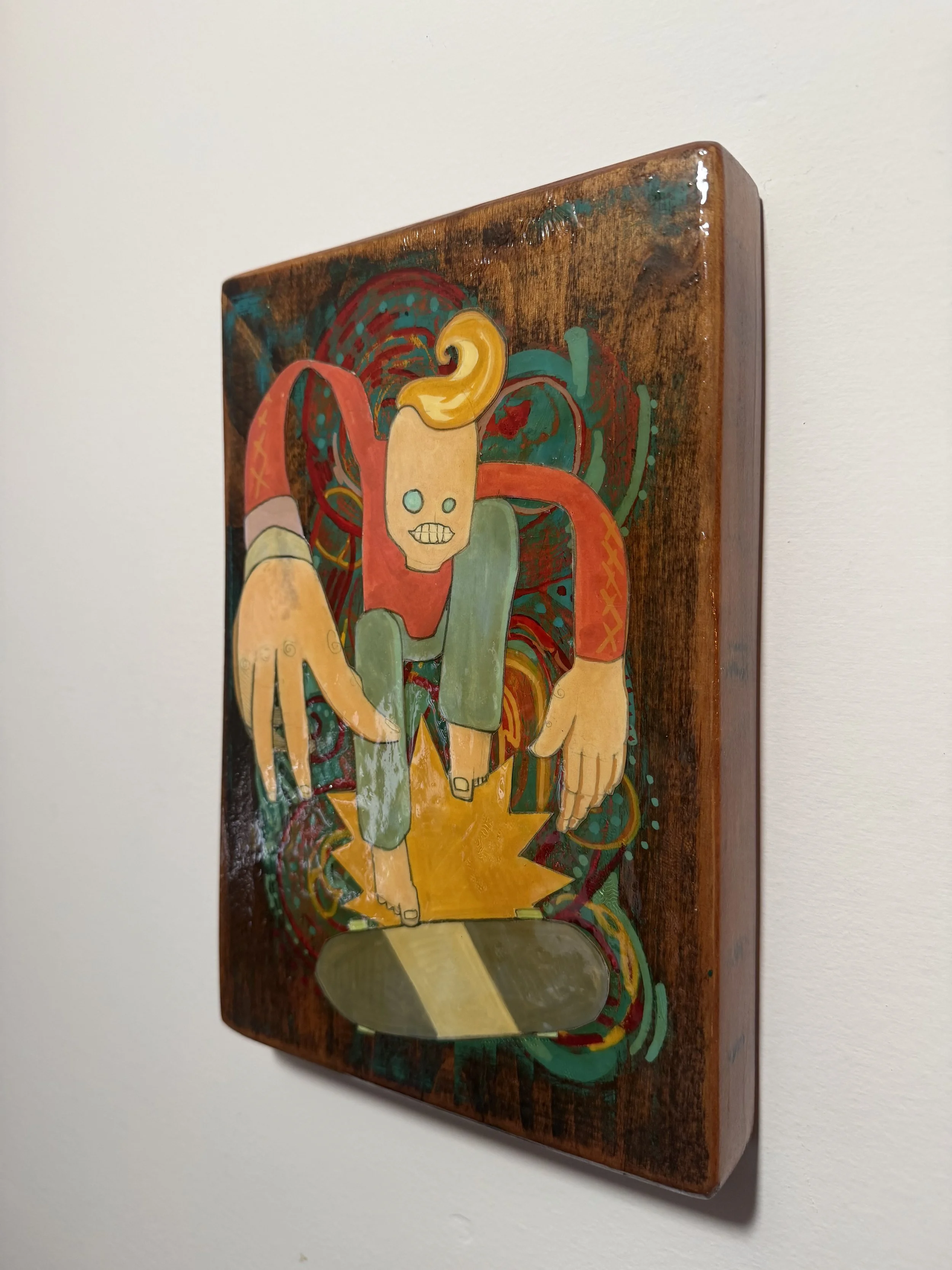 Colorful abstract art illustration on a wooden surface showing a figure with a skull face, green clothes, and yellow hair, surrounded by swirling patterns.