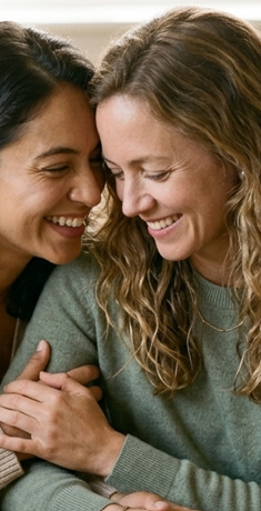 Two women sharing a warm, connected moment, representing feeling secure and supported in relationships after overcoming anxiety and overthinking