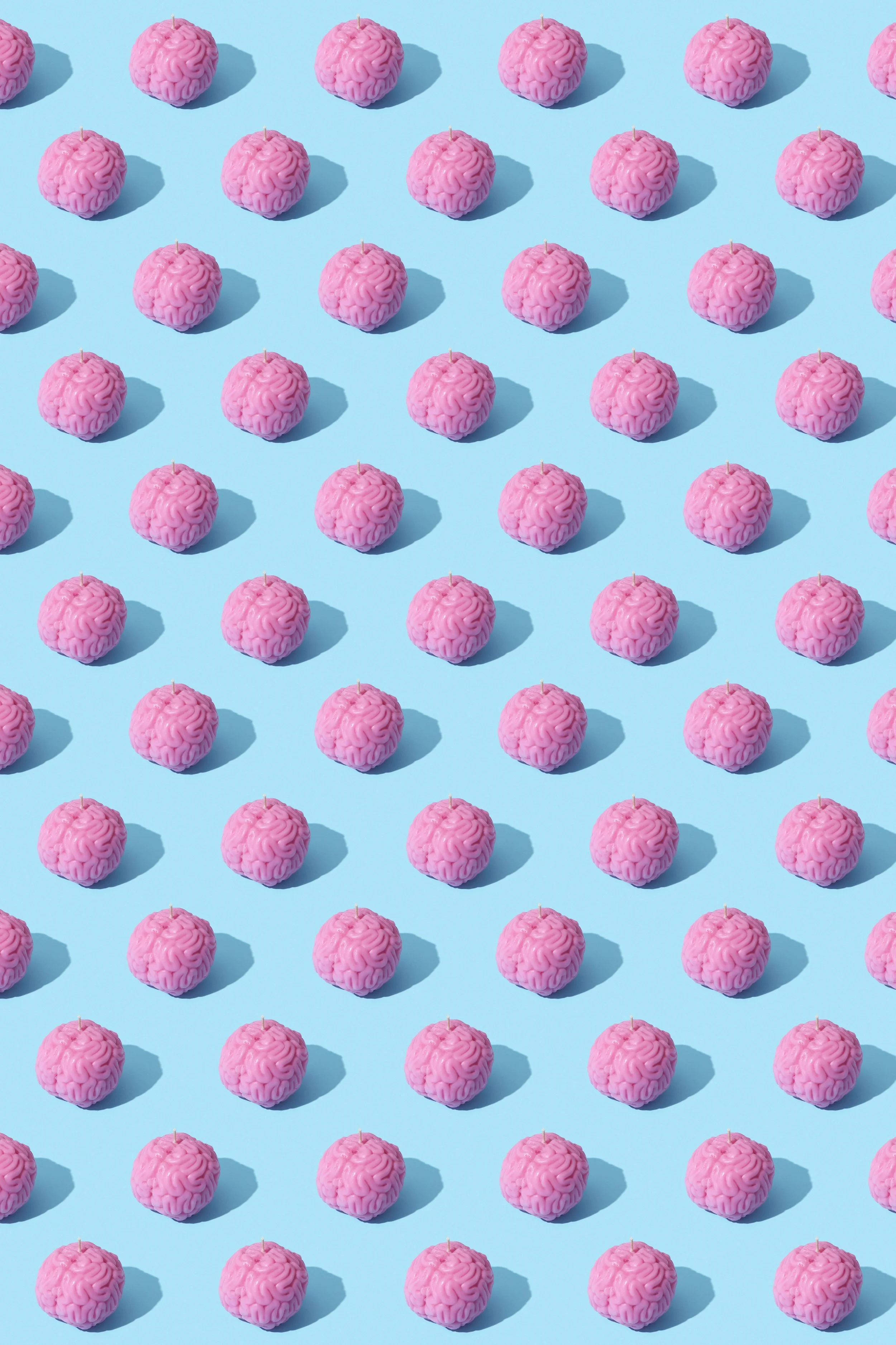 Pattern of small pink brains arranged in rows against a light blue background.