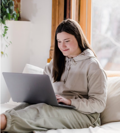 Adult participating in online therapy to work with anxiety and nervous system responses.