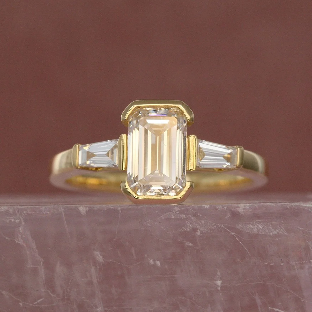 Matching engagement rings, made for Natalie &amp; Dominic 💍

Dominic surprised Natalie with this gorgeous custom made Art Deco-inspired trilogy ring, and she said yes! Then Natalie &amp; I created this funky asymmetric gold ring for Dom, with three 