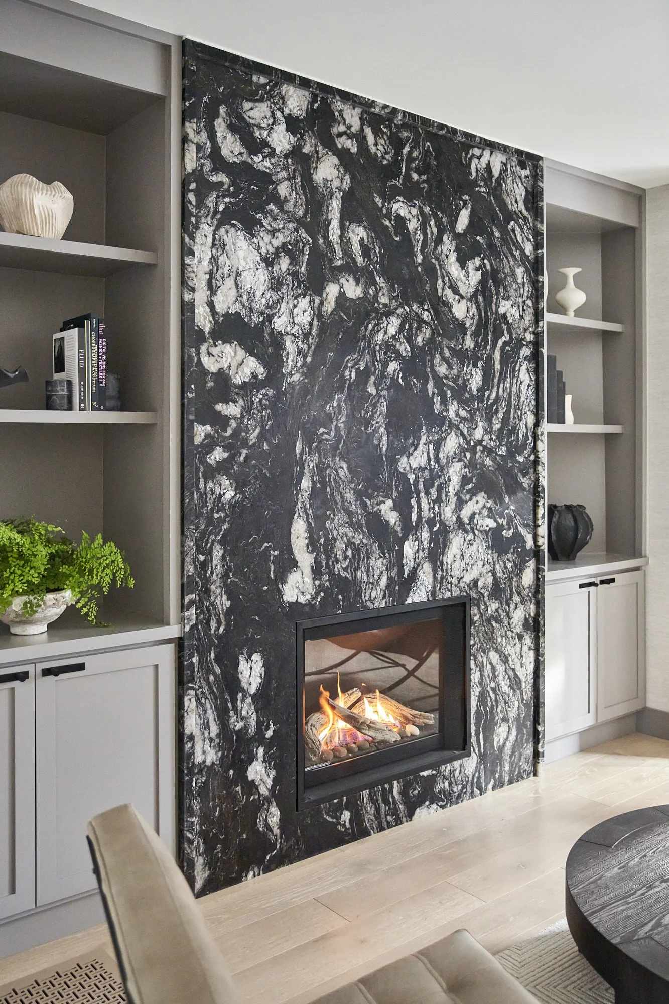 A striking marble fireplace in this San Francisco living room by Retiro Design Co evokes quiet luxury. 