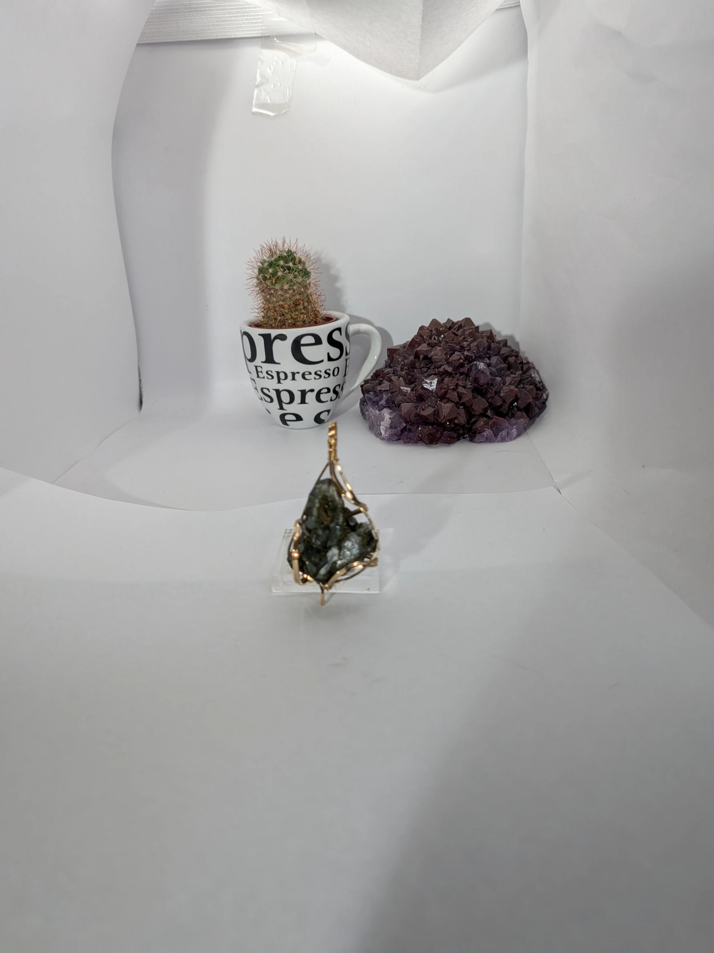 Gorgeous raw epidote, intricately wire-wrapped, beautifully highlighting the stone as the centrepiece.