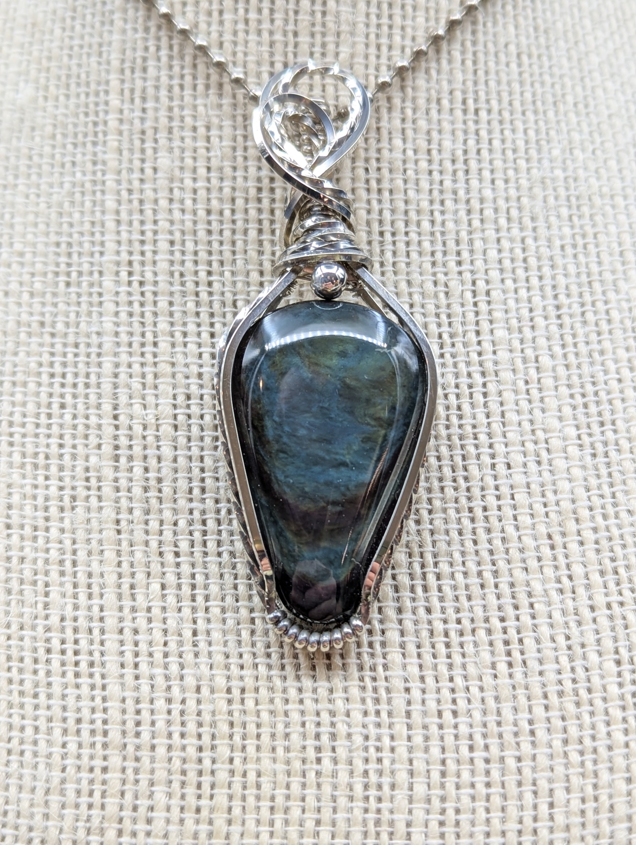 Peacock Obsidian repels negative energy and overflows with positive energy for those who carry it. It's like the sunshine through the dark stormy clouds, clearing past obstacles for a brighter future.