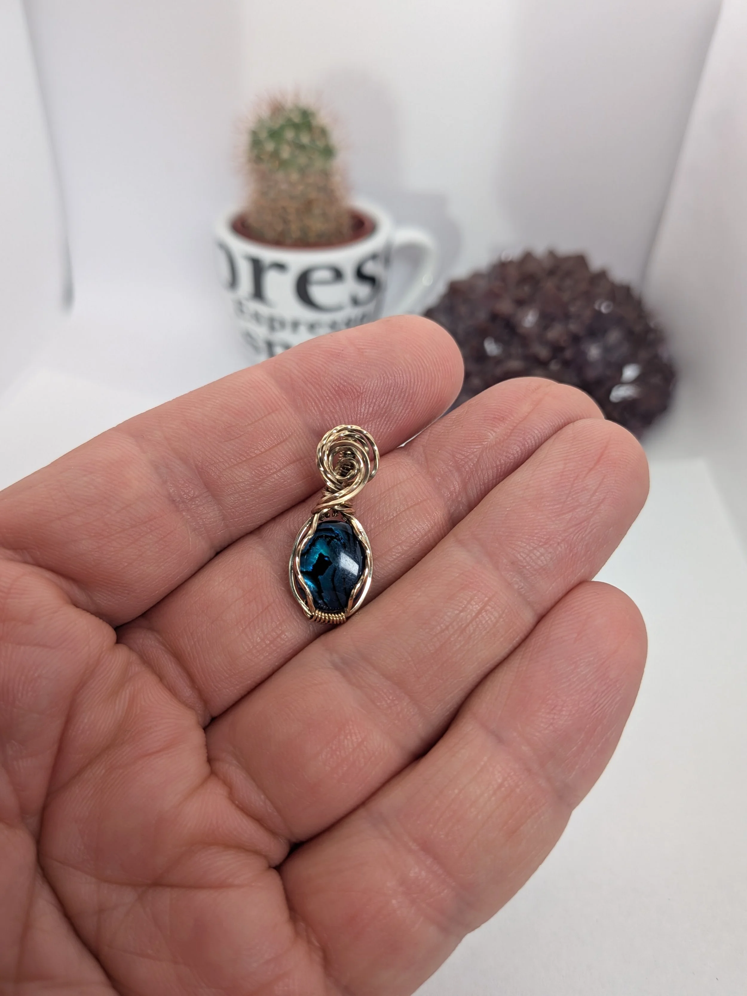 Gorgeous petite gemstone pendant, intricately wire-wrapped and accented with a heart-style bail, beautifully highlighting the stone as the centrepiece.