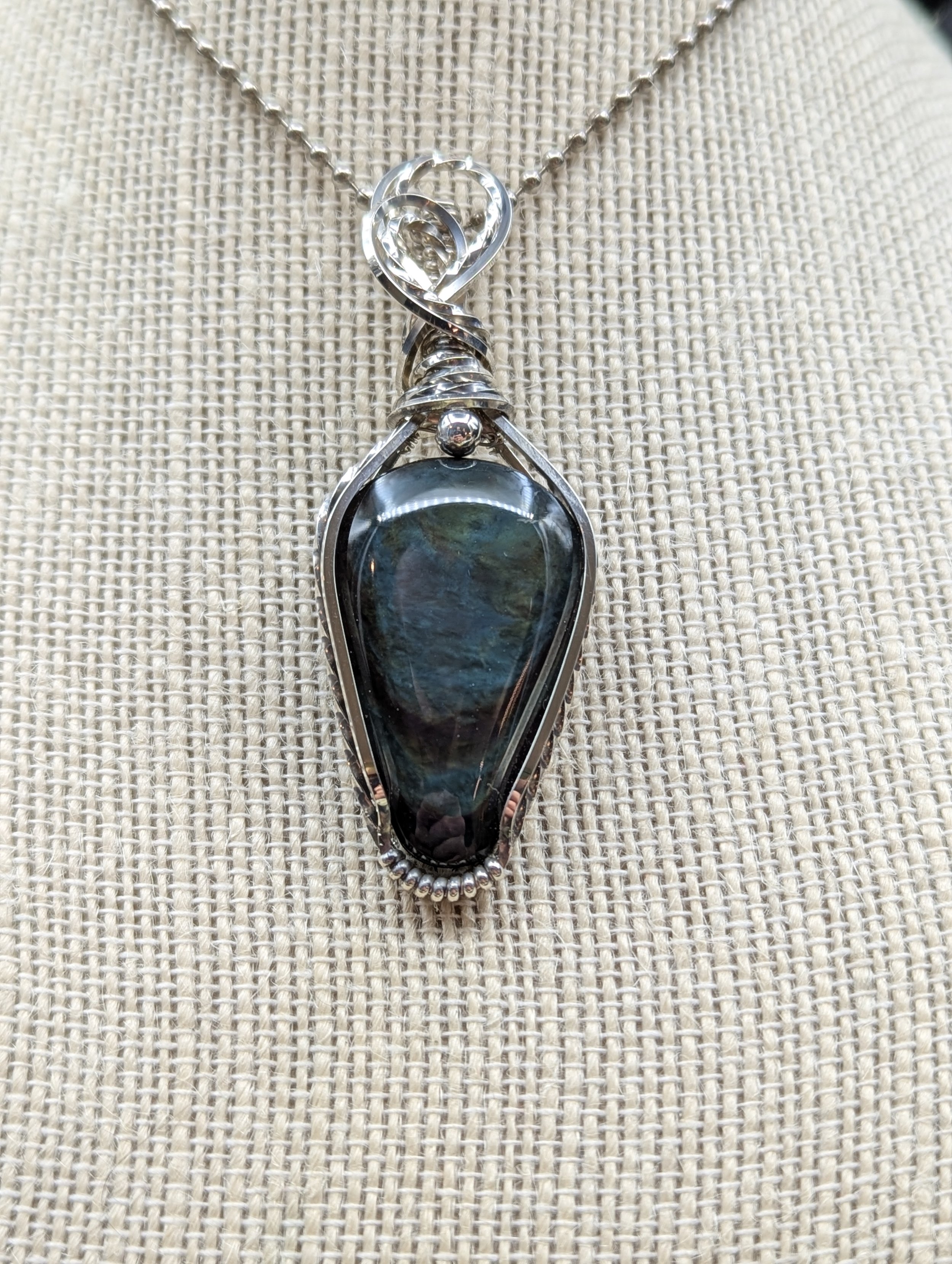 Peacock Obsidian repels negative energy and overflows with positive energy for those who carry it. It's like the sunshine through the dark stormy clouds, clearing past obstacles for a brighter future.