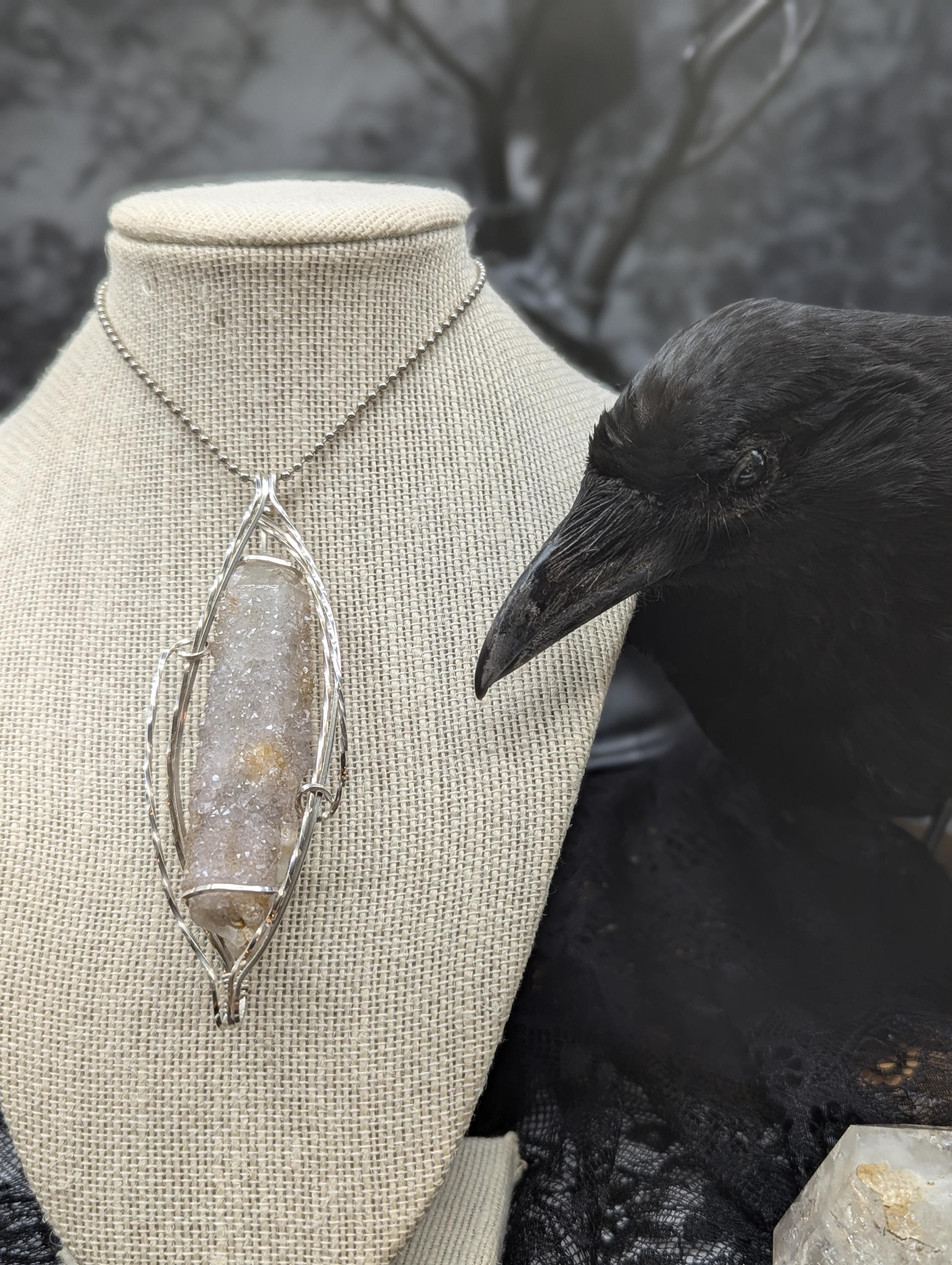 Elegant wire-wrapped spirit quartz in a large sparkling purple-pink hue, with twisted sterling wire cascading along both sides to highlight the stunning focal point.