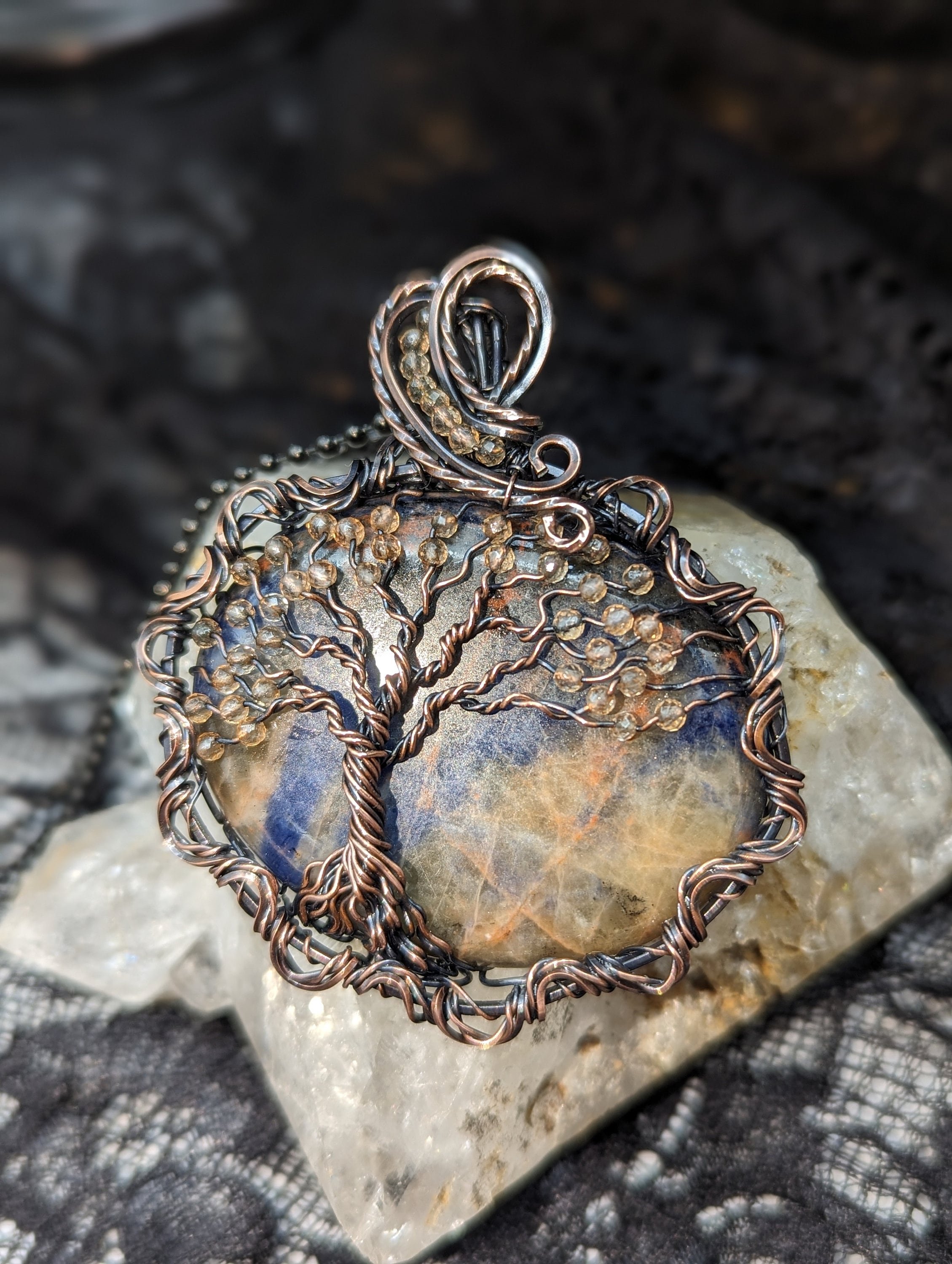 Orange Sodalite thumb stone pendant for meditation, wire wrapped with a Tree of Life and citrine bead accents, featuring an elegant twisted copper wire border.