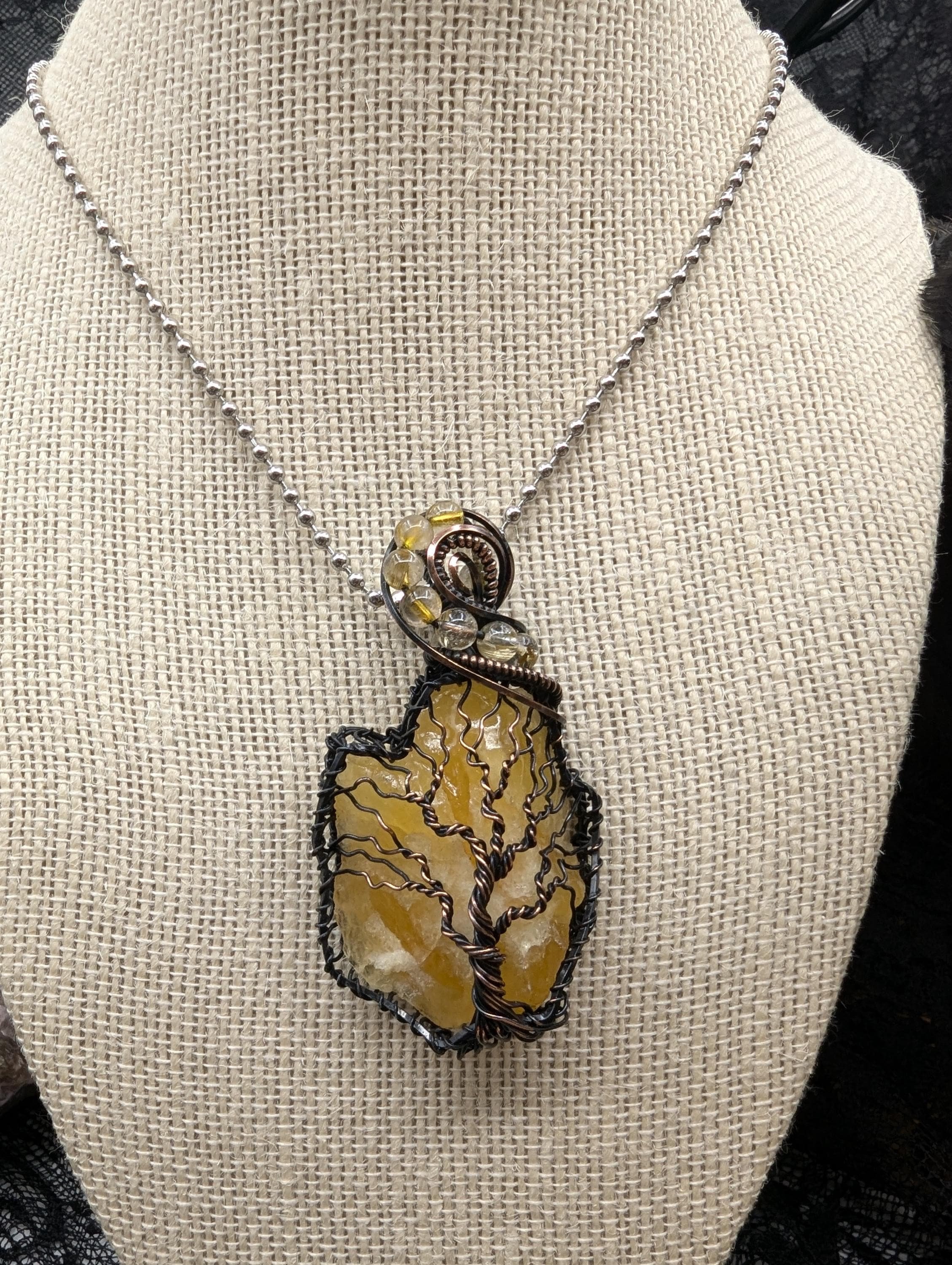 Stunning Raw Golden Yellow Calcite pendant, elegantly wrapped in copper wire with a beautiful Tree of Life design. Adorned with flowing Rutile quartz accent beads for added charm.