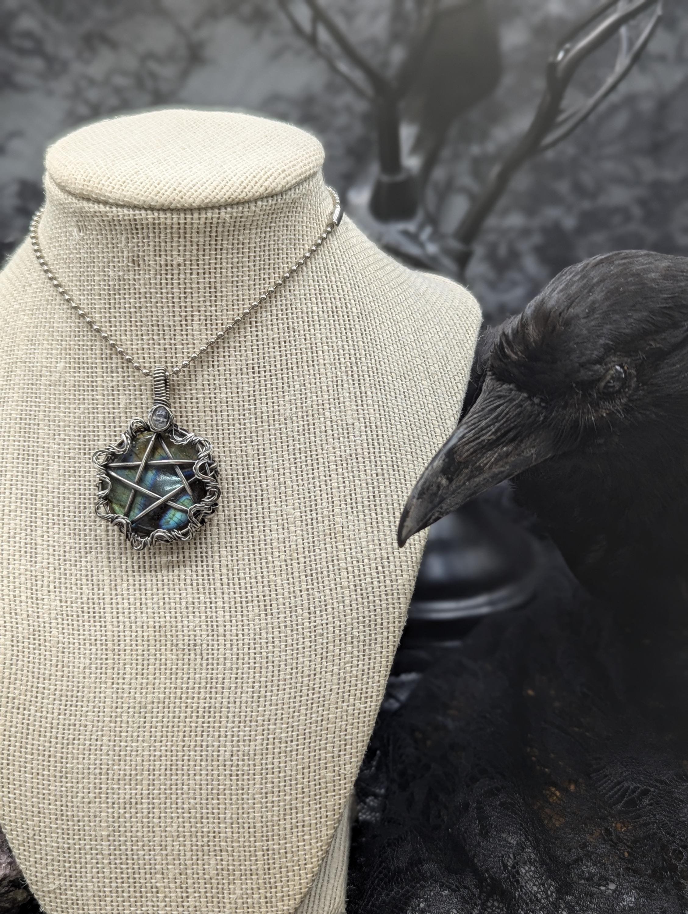 Stunning round labradorite pendant, elegantly wire-wrapped with a striking pentagram design. Enhanced by a wavy twisted wire border and a labradorite bead on the bail.