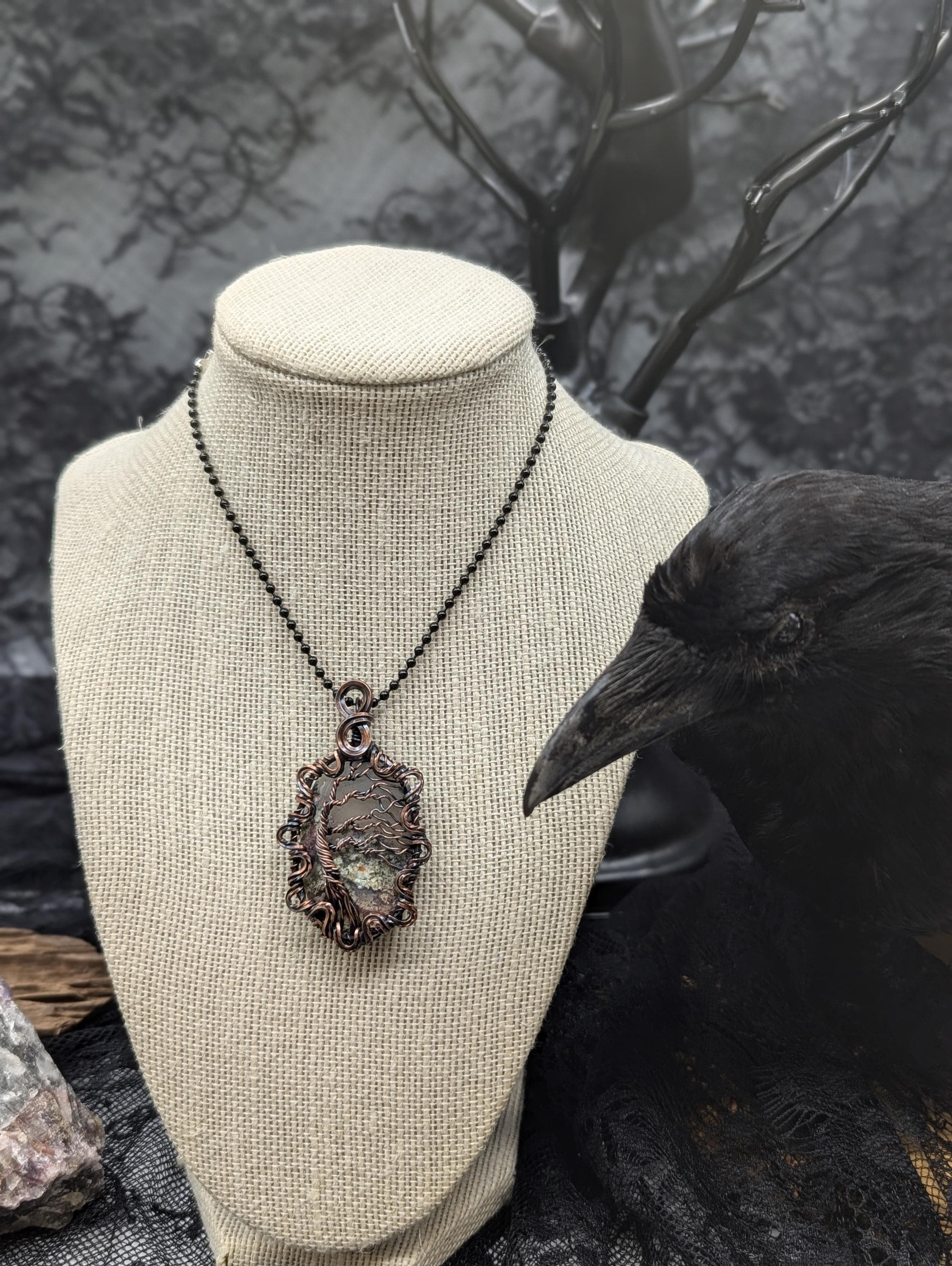A stunning teardrop garden quartz pendant, elegantly wire-wrapped with a tree of life design that gives a 3D leaf effect, complete with a twisted border and infinity bail.