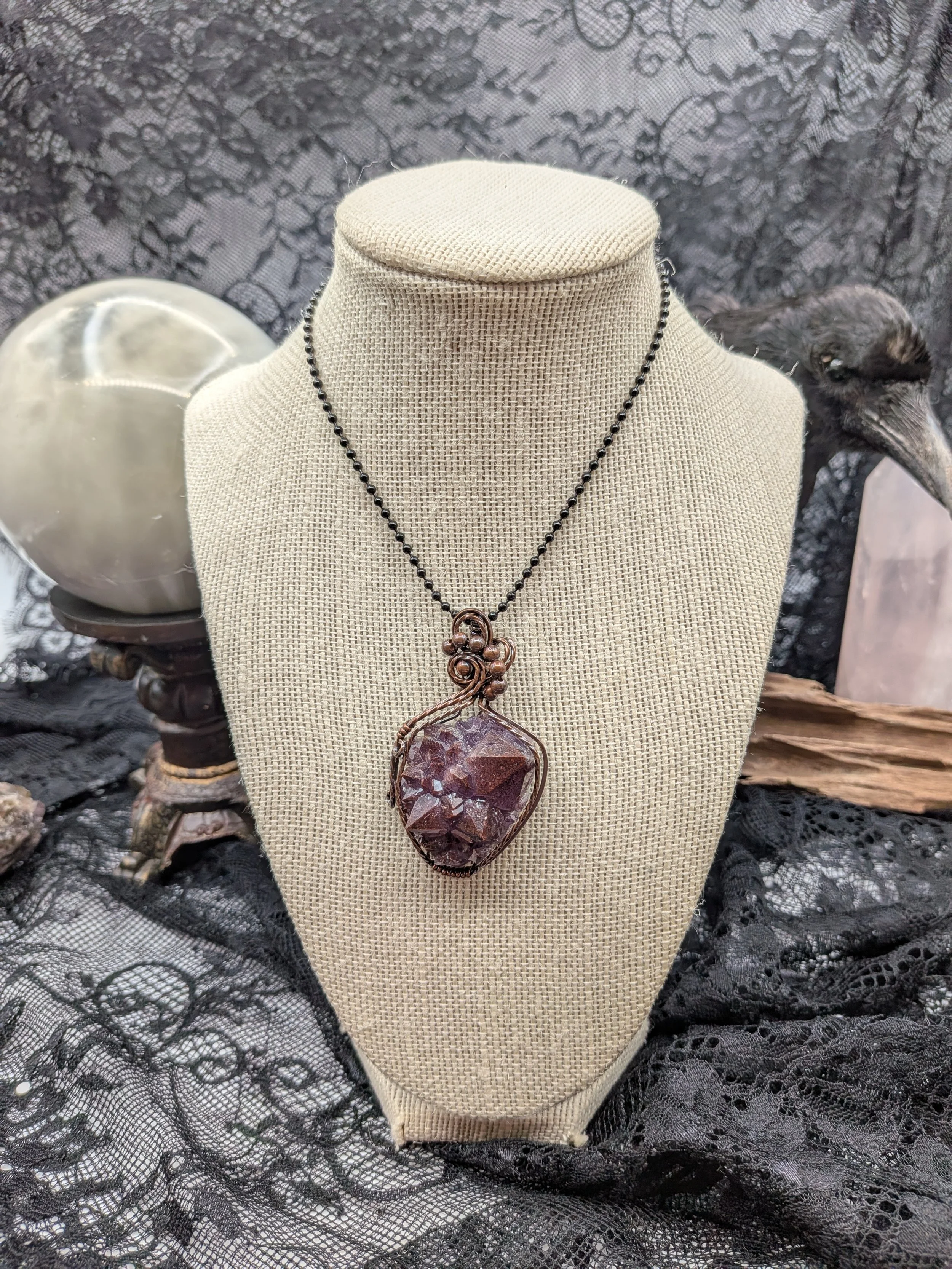 A stunning Thunder Bay amethyst cluster wrapped in Viking copper wire, elegantly accented with wavy copper to highlight the amethyst as the focal point.jpg