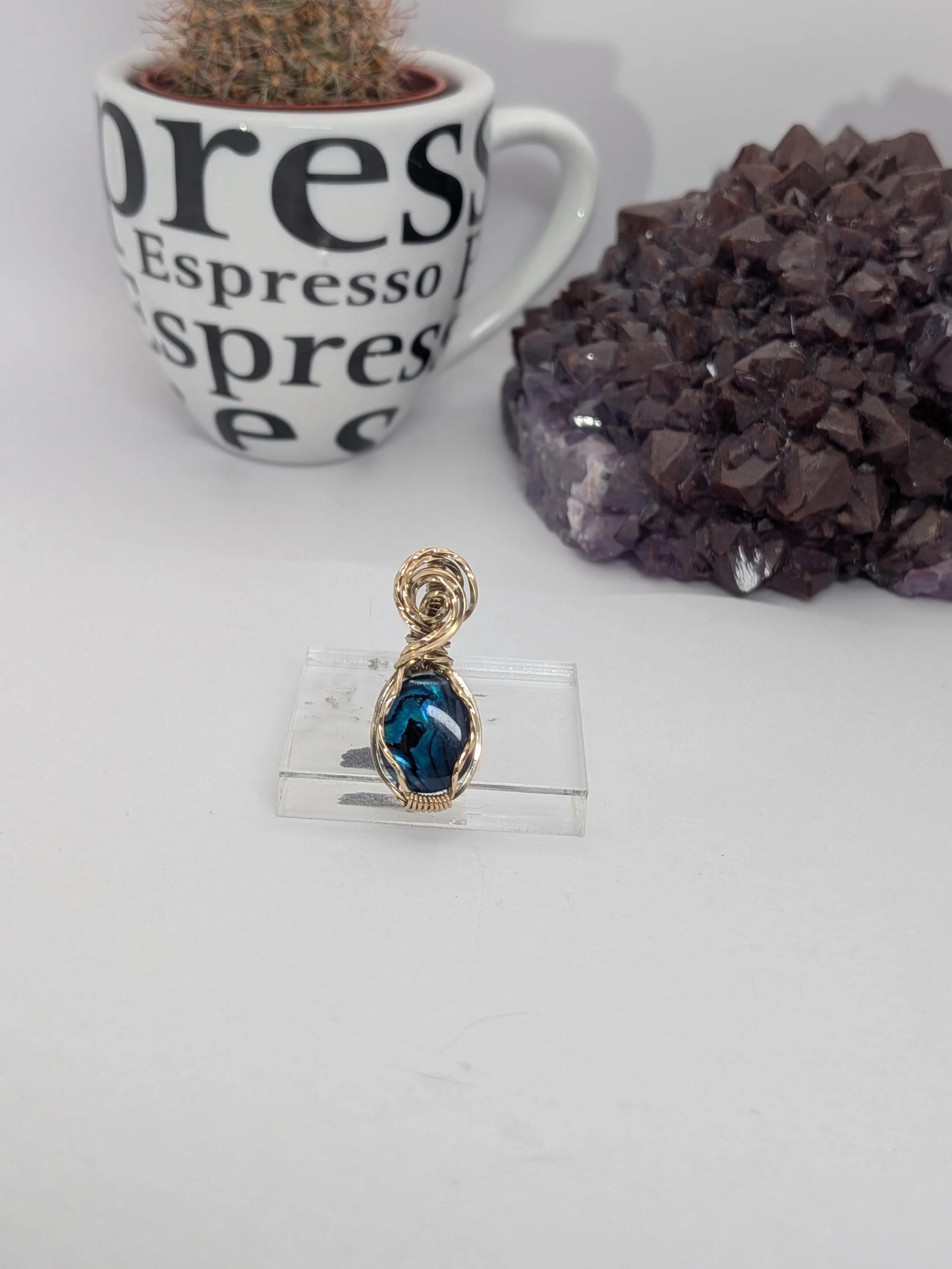 Gorgeous petite gemstone pendant, intricately wire-wrapped and accented with a heart-style bail, beautifully highlighting the stone as the centrepiece.