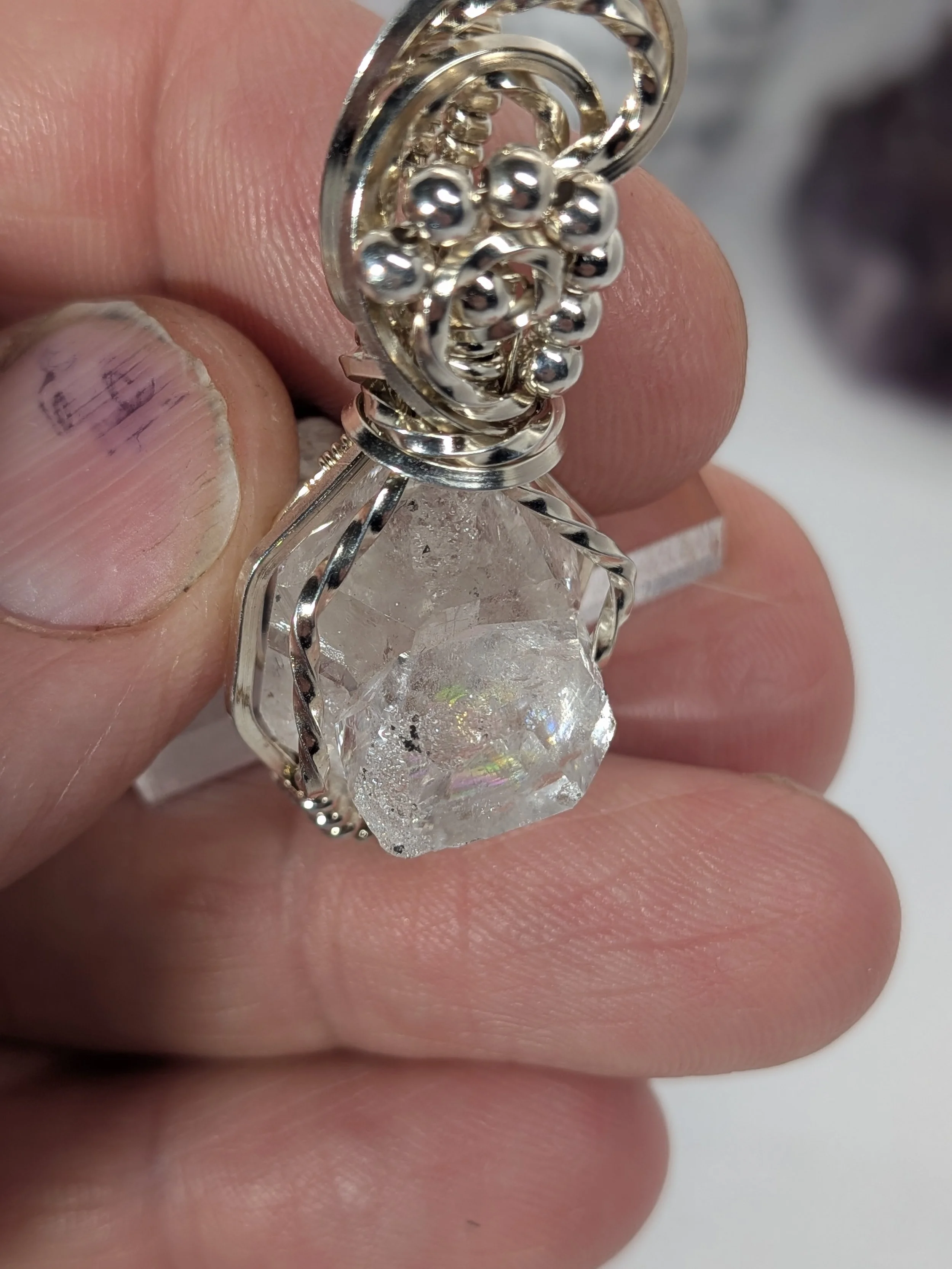Extra large Herkimer diamond wrapped in antiqued sterling silver wire features an elegant wavy wire bail, with wire twisting and cascading down both sides of the diamond.