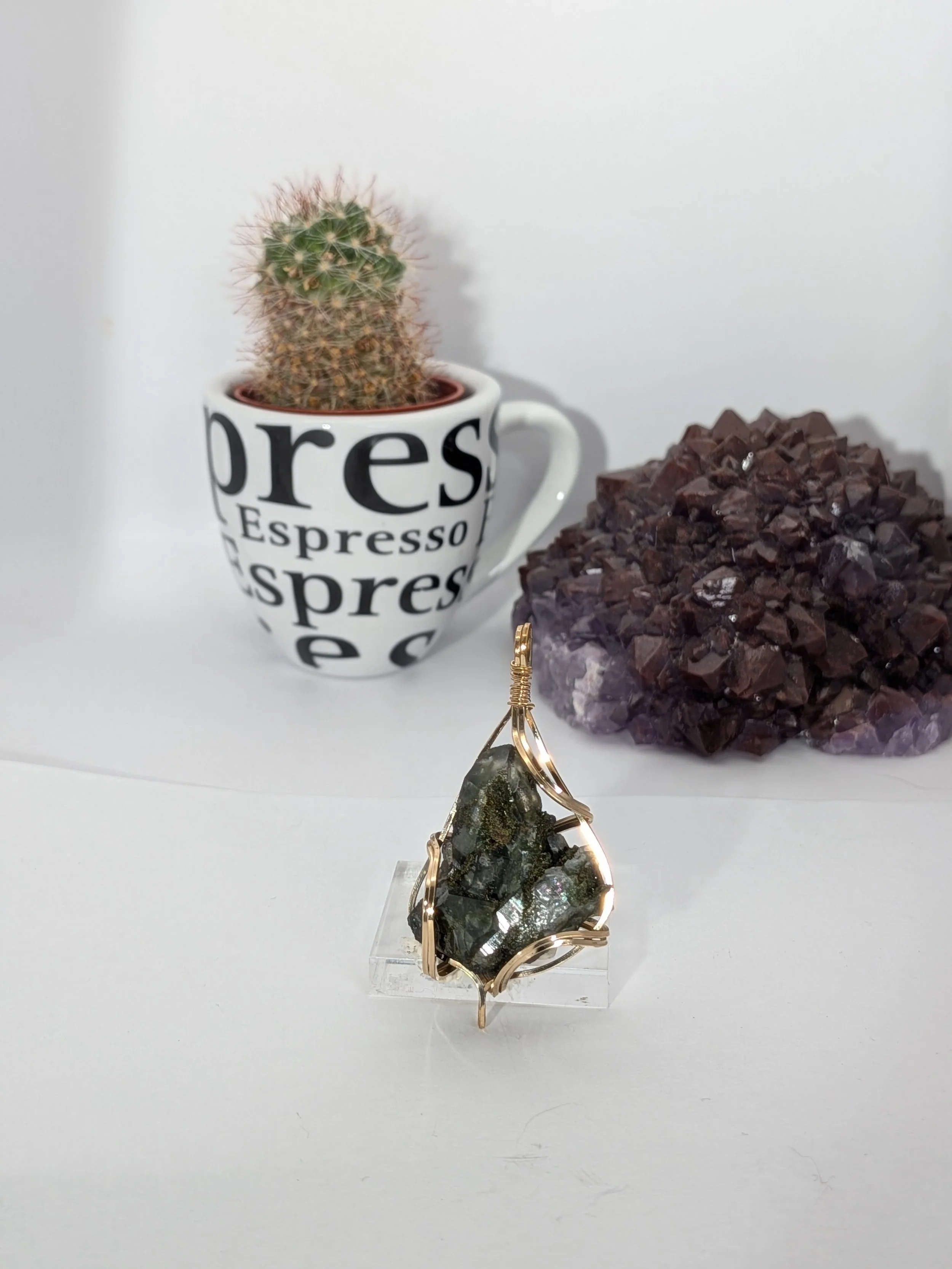 Gorgeous raw epidote, intricately wire-wrapped, beautifully highlighting the stone as the centrepiece.