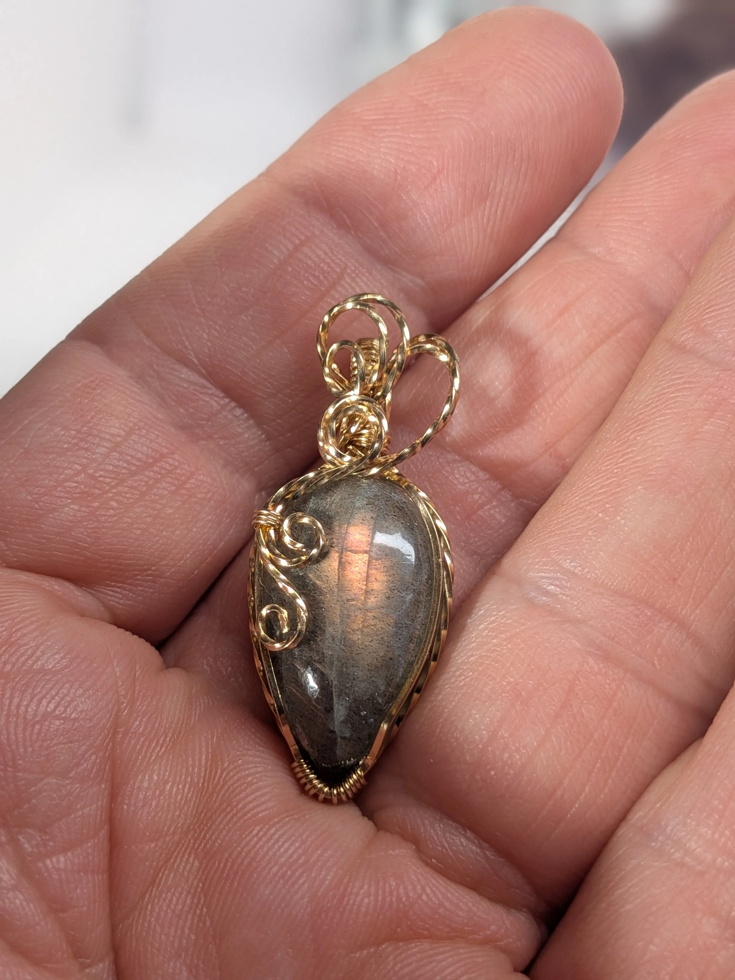 Gorgeous petite labradorite pendant, intricately wire-wrapped and accented with a heart-style bail, beautifully highlighting the stone as the centrepiece.