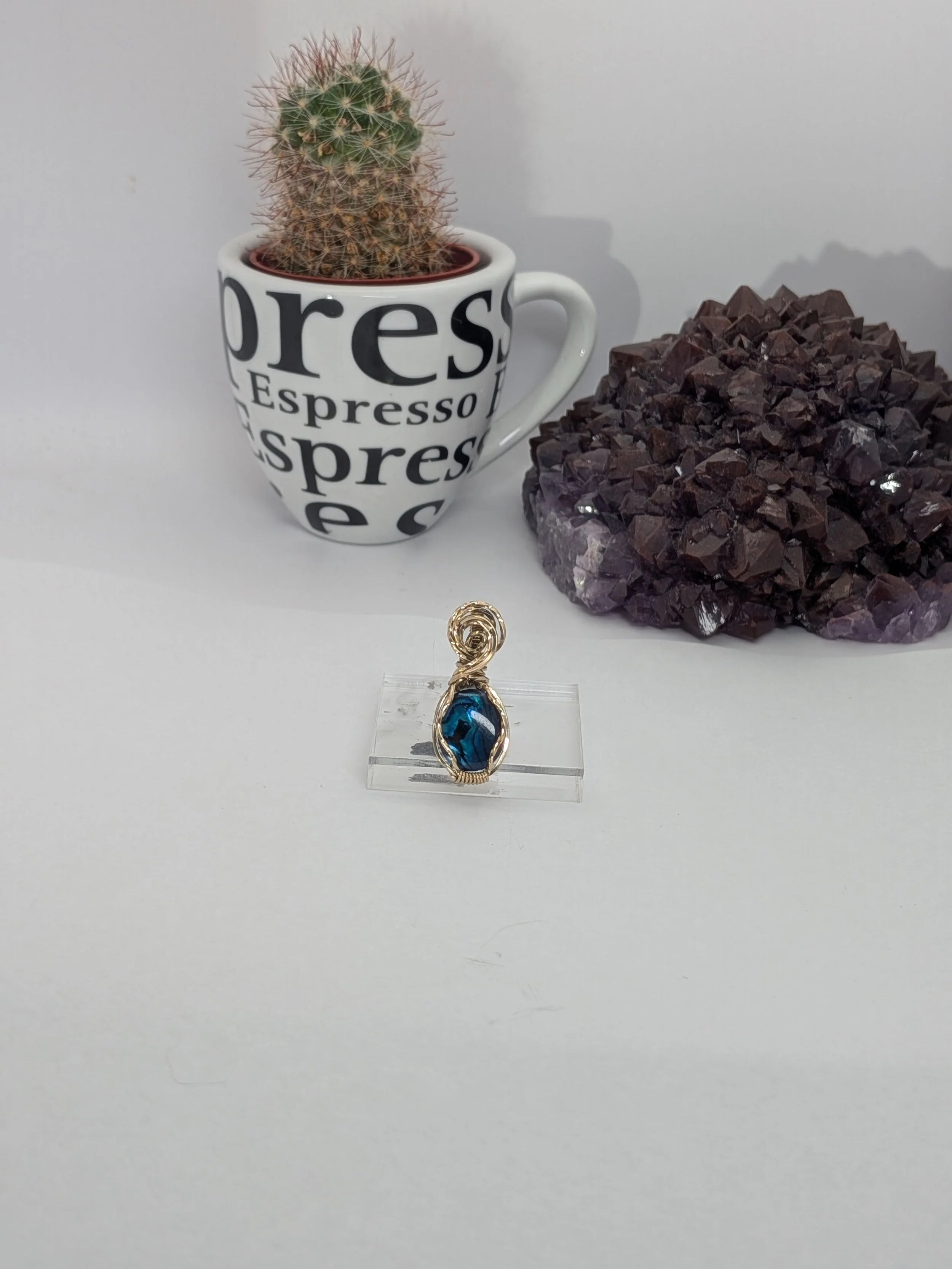 Gorgeous petite gemstone pendant, intricately wire-wrapped and accented with a heart-style bail, beautifully highlighting the stone as the centrepiece.