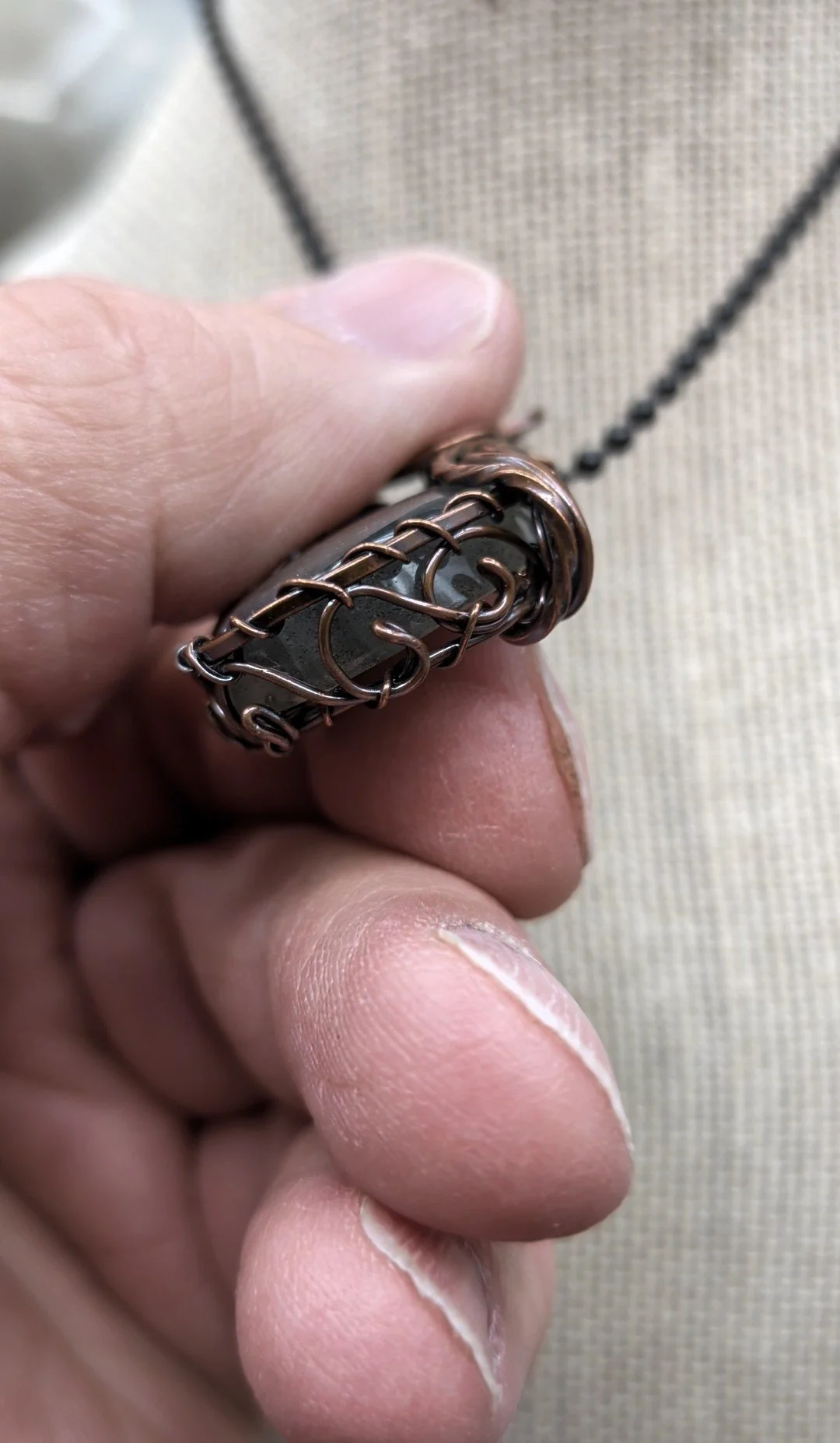 Gorgeous petite teardrop labradorite pendant, intricately wire-wrapped and accented with a heart-style bail, beautifully highlighting the stone as the centerpiece. jpg