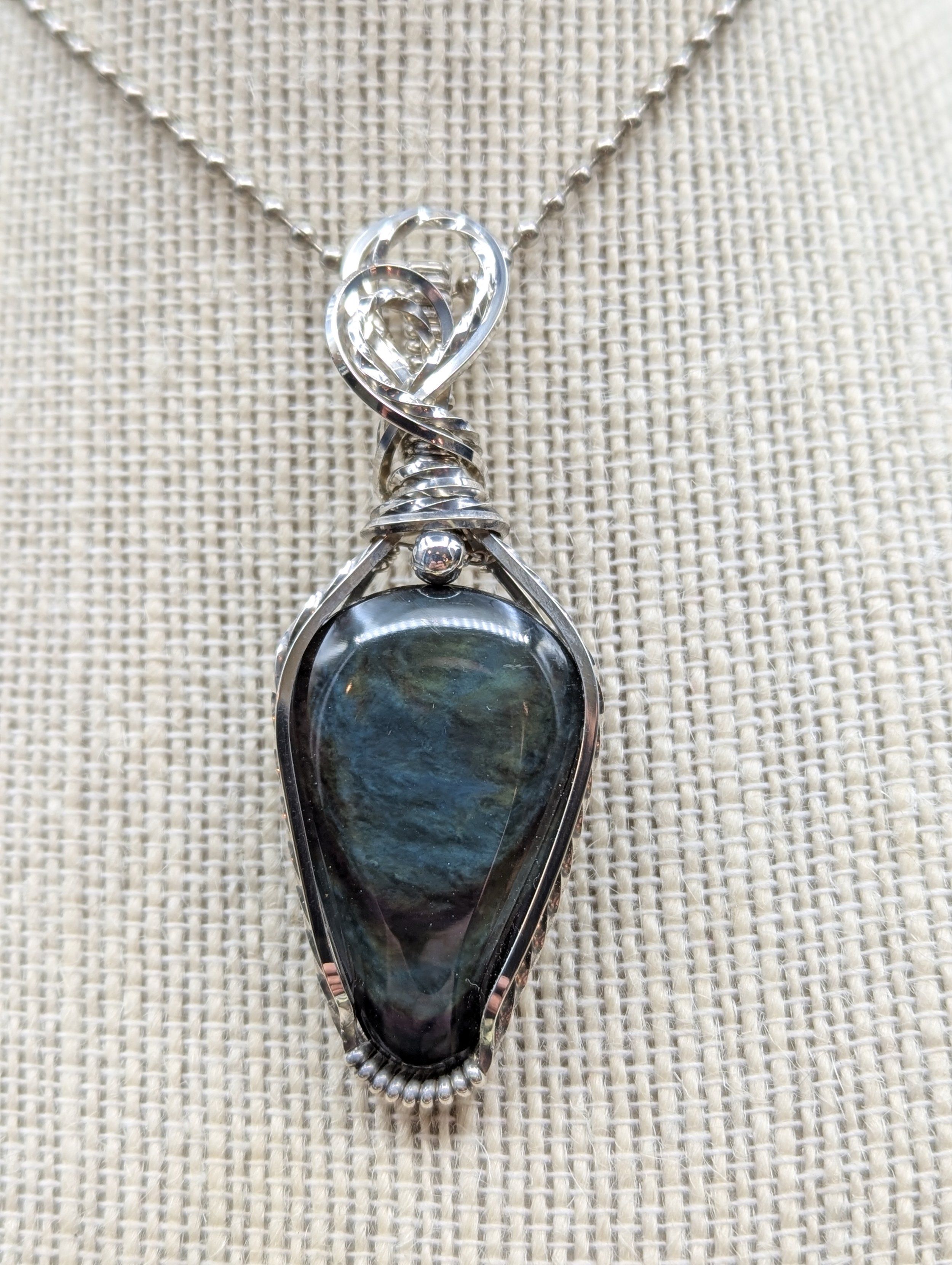 Peacock Obsidian repels negative energy and overflows with positive energy for those who carry it. It's like the sunshine through the dark stormy clouds, clearing past obstacles for a brighter future.