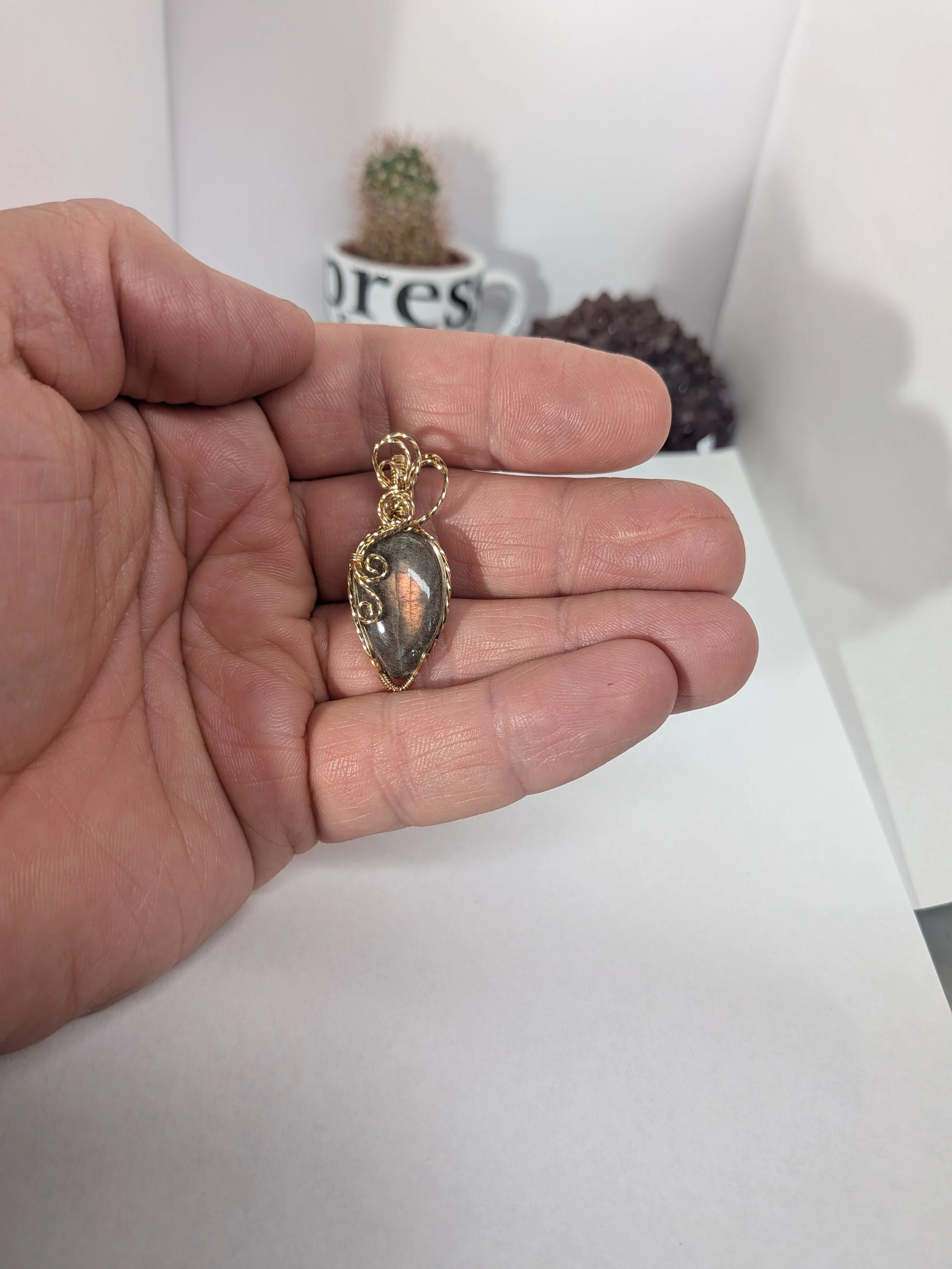 Gorgeous petite labradorite pendant, intricately wire-wrapped and accented with a heart-style bail, beautifully highlighting the stone as the centrepiece.