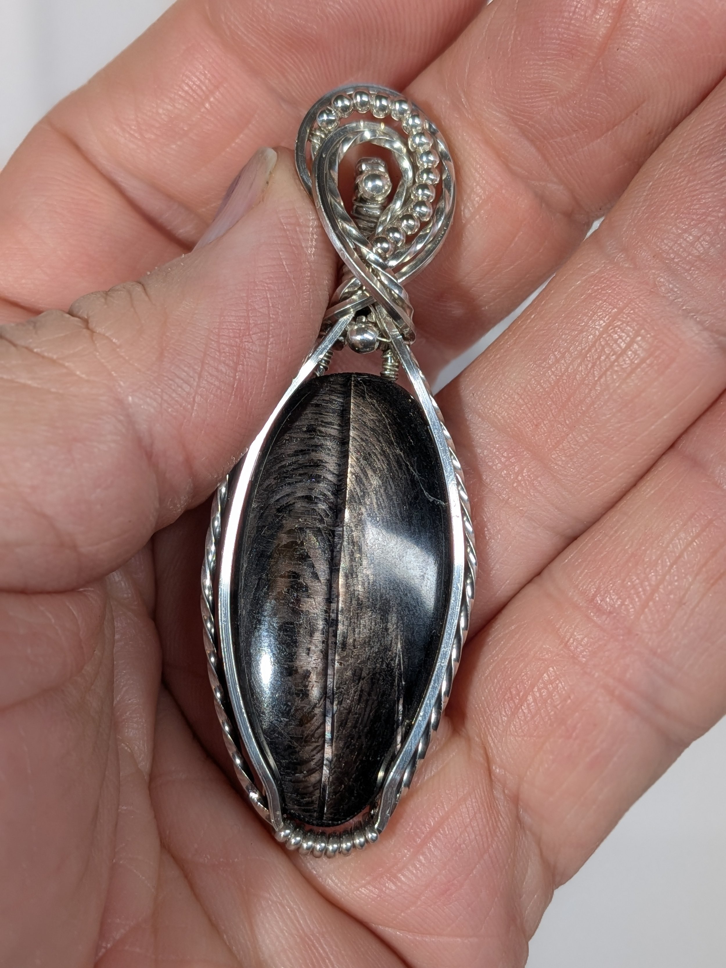 Gorgeous petite gemstone pendant, intricately wire-wrapped and accented with a heart-style bail, beautifully highlighting the stone as the centrepiece.