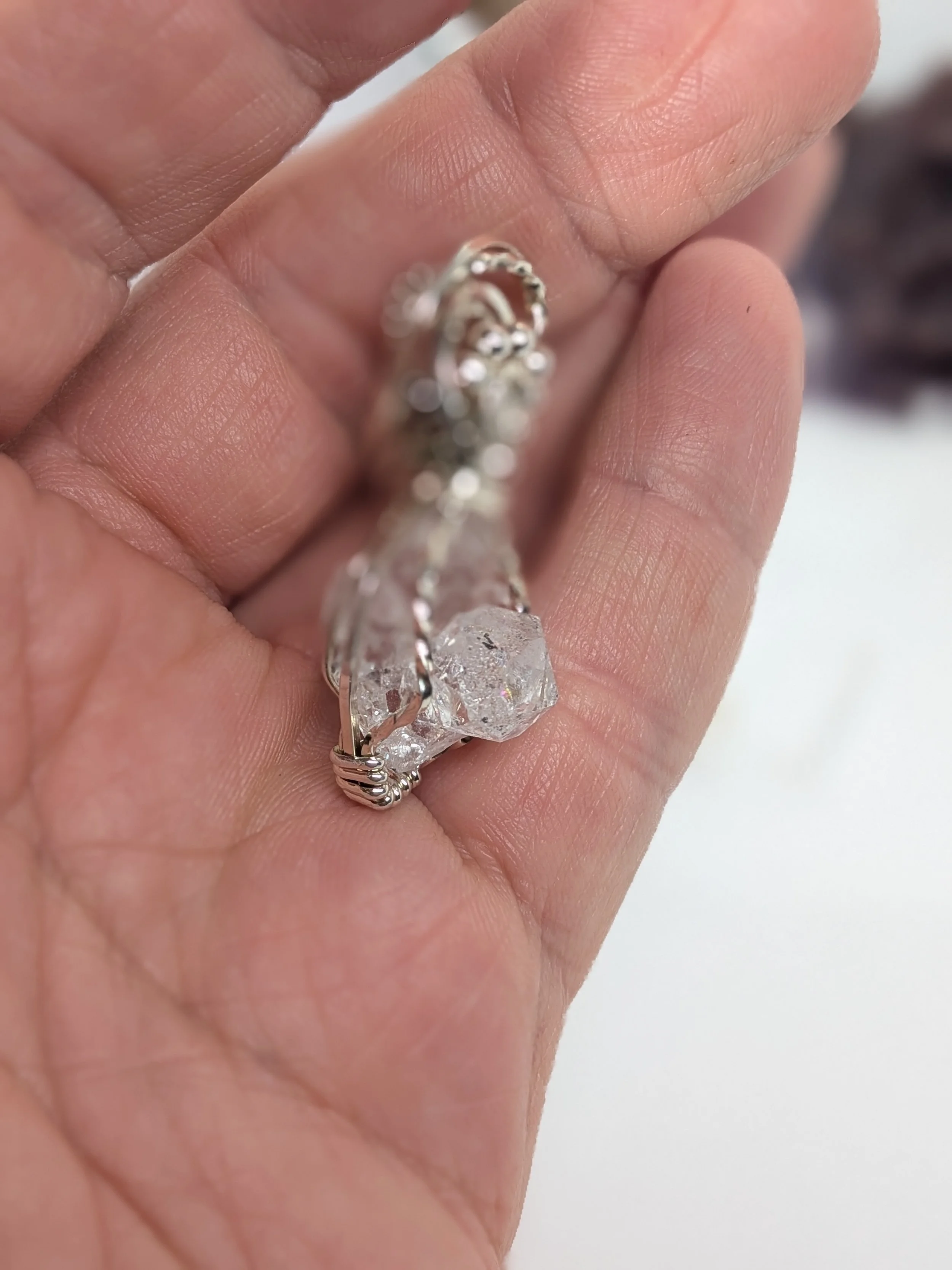 Extra large Herkimer diamond wrapped in antiqued sterling silver wire features an elegant wavy wire bail, with wire twisting and cascading down both sides of the diamond.