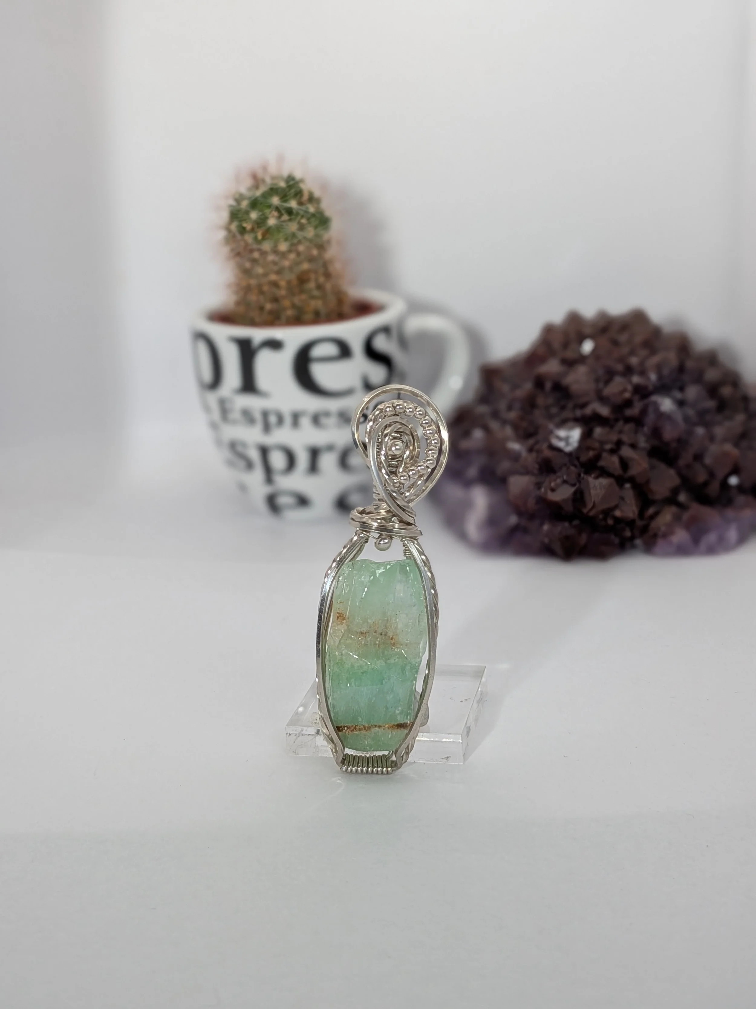 Sterling silver wire wrapped large green calcite gemstone, adorned with small silver beads for an elegant finish.